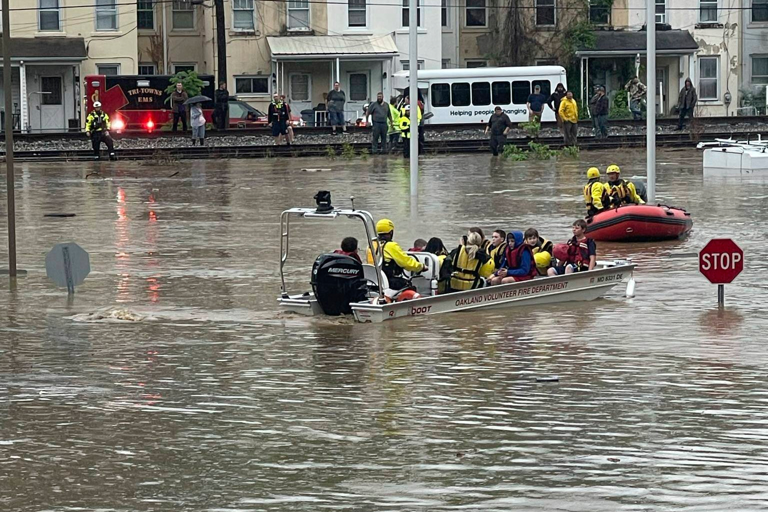 In a photo provided by Alley and Tim Wade, students are being rescued by boat after flash flooding in Westernport, MD., Tuesday, May 13, 2025. (Alley and Tim Wade via AP)