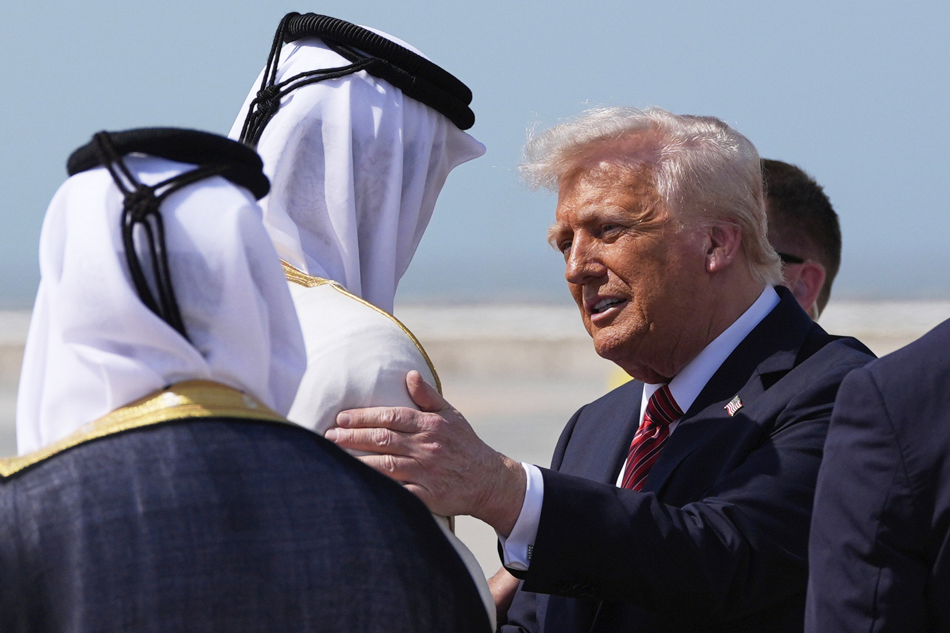 President Donald Trump is greeted by Qatar's Emir Sheikh Tamim bin Hamad Al Thani as he arrives on Air Force One at Hamad International Airport in Doha, Qatar, Wednesday, May 14, 2025. (AP Photo/Alex Brandon)