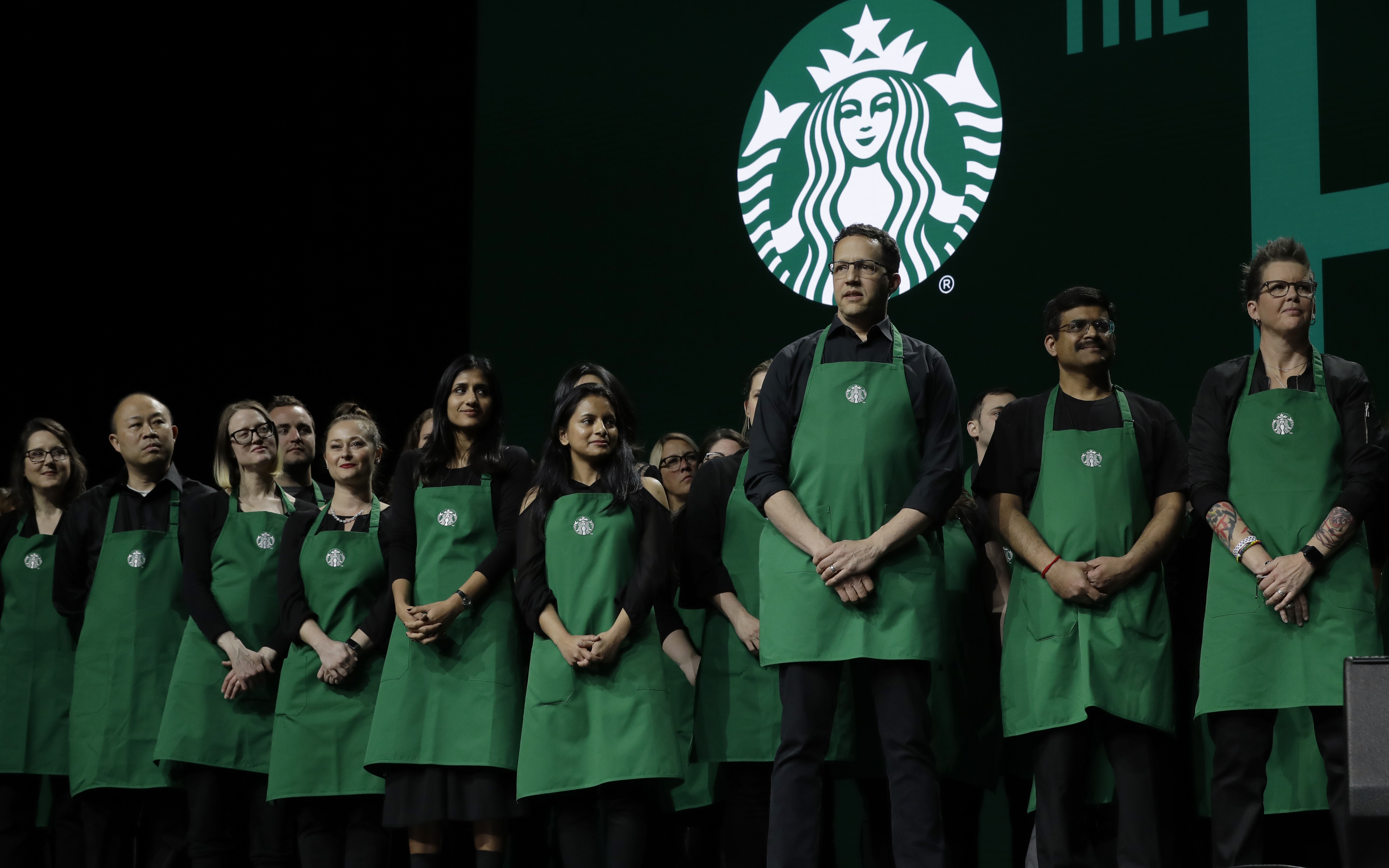 FILE - Starbucks baristas stand on stage, March 20, 2019, during an annual shareholders meeting in Seattle. (AP Photo/Ted S. Warren, file)