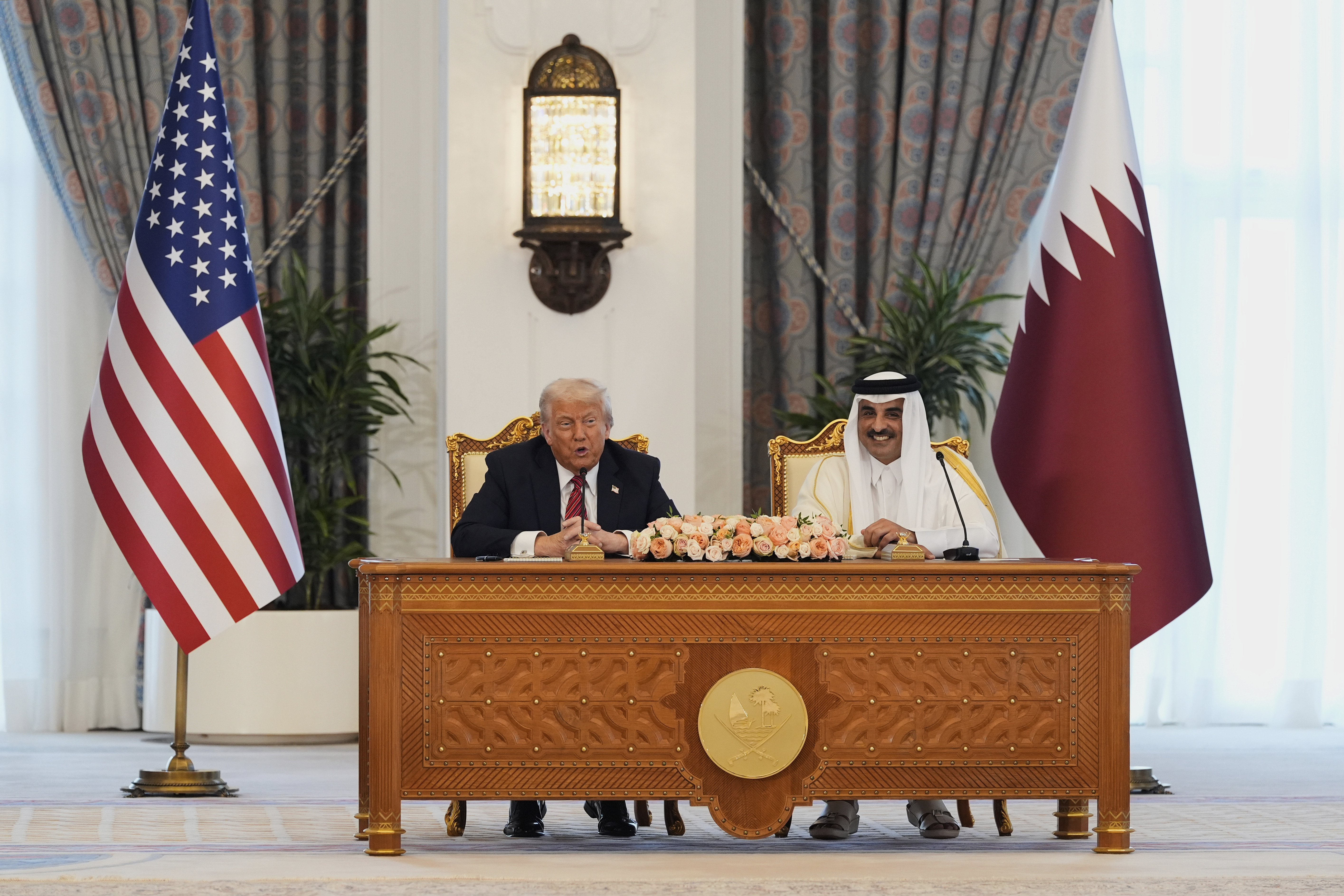 President Donald Trump and Qatar's Emir Sheikh Tamim bin Hamad Al Thani attend a signing ceremony at the Amiri Diwan in Doha, Qatar, Wednesday, May 14, 2025. (AP Photo/Alex Brandon)
