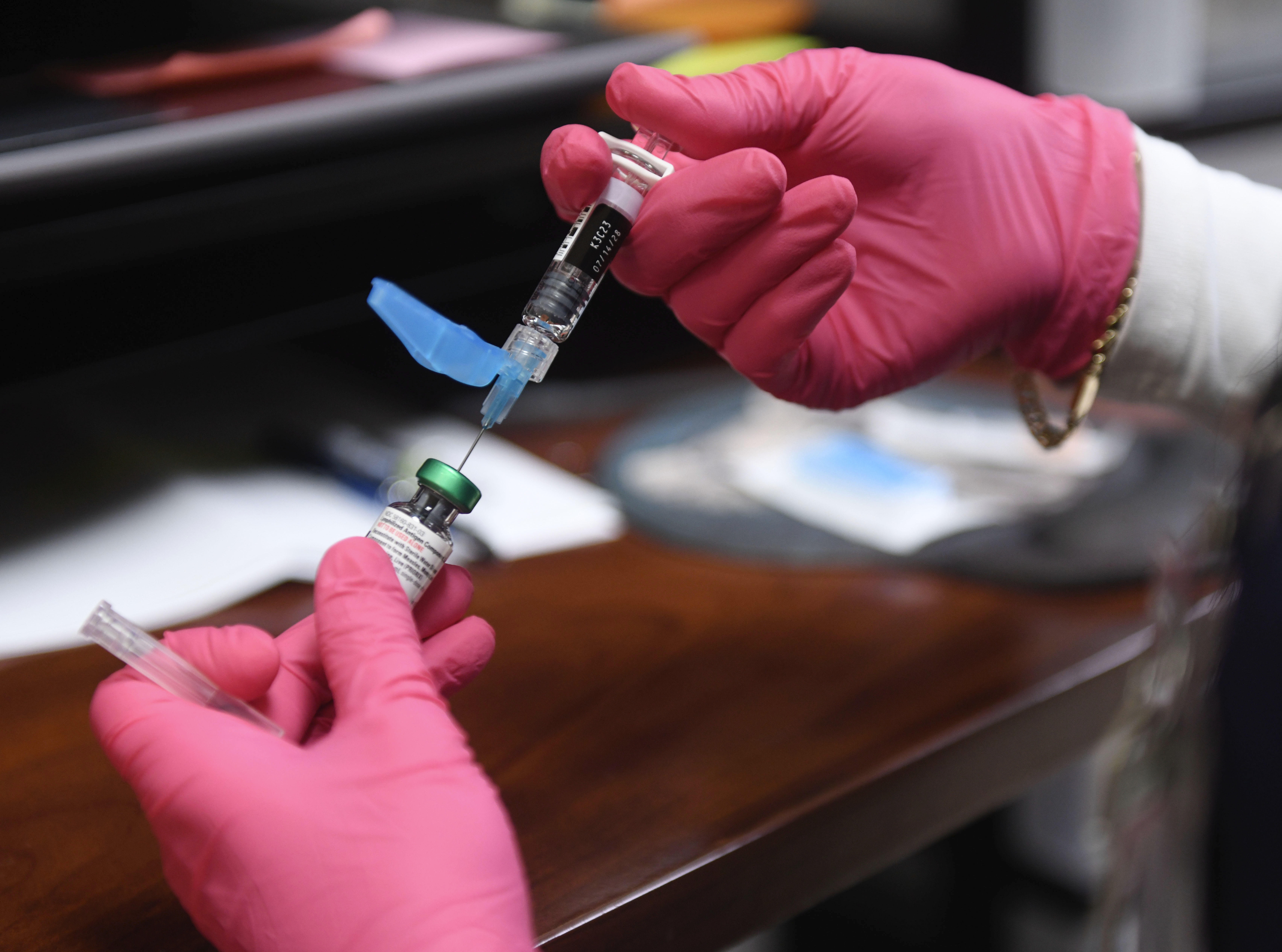 Anna Hicks prepares a measles, mumps and rubella vaccine at the Andrews County Health Department, Tuesday, April 8, 2025, in Andrews, Texas. (AP Photo/Annie Rice)
