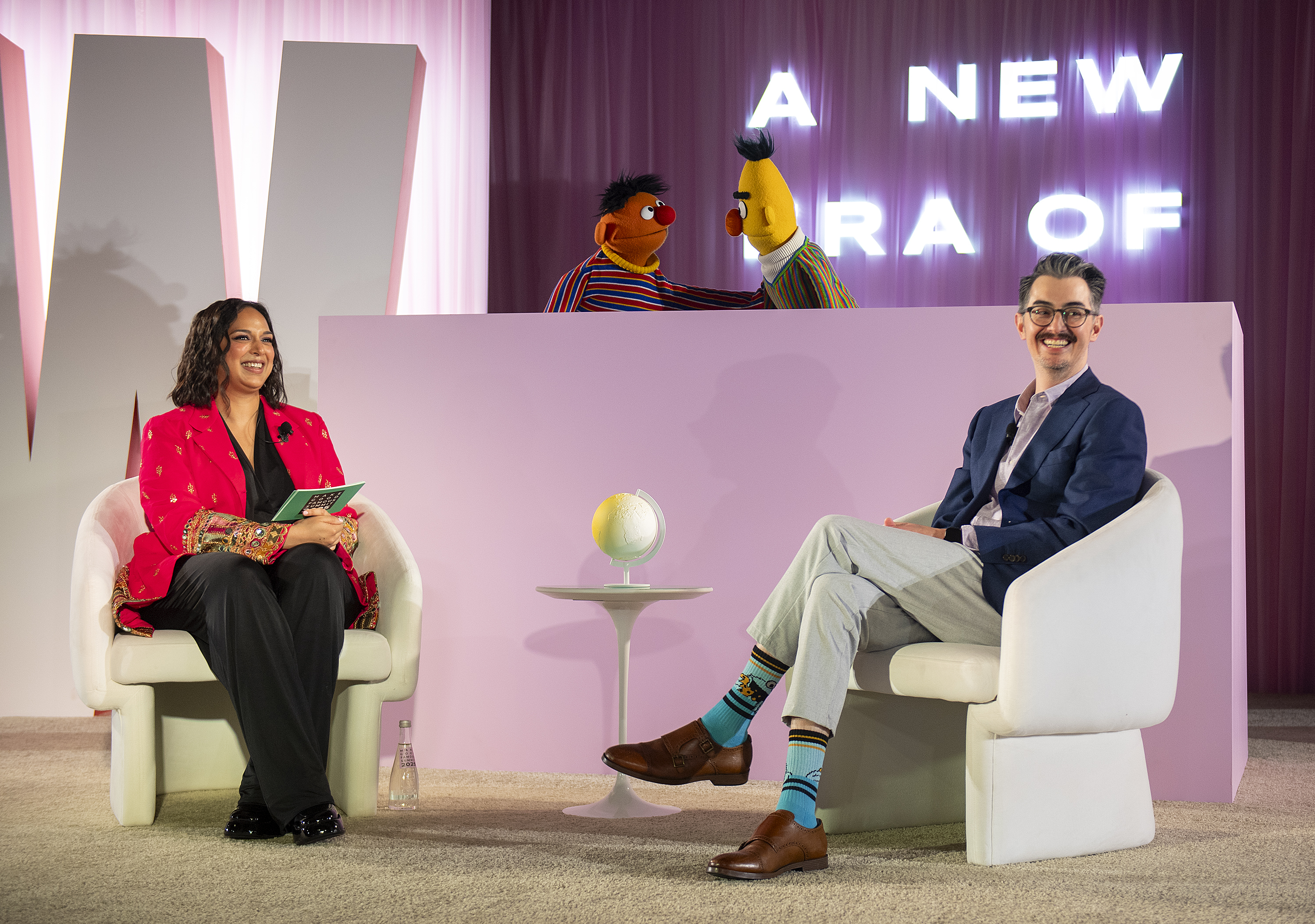 Sal Perez, executive producer and VP of Sesame Street at Sesame Workshop, right, and Versha Sharma, editor-in-chief at Teen Vogue, talk to Burt and Ernie after Sesame Workshop won the Elevate Prize Foundation's Catalyst Award, Wednesday, May 14, 2025, in Miami Beach, Fla. (AP Photo/Michael Laughlin)