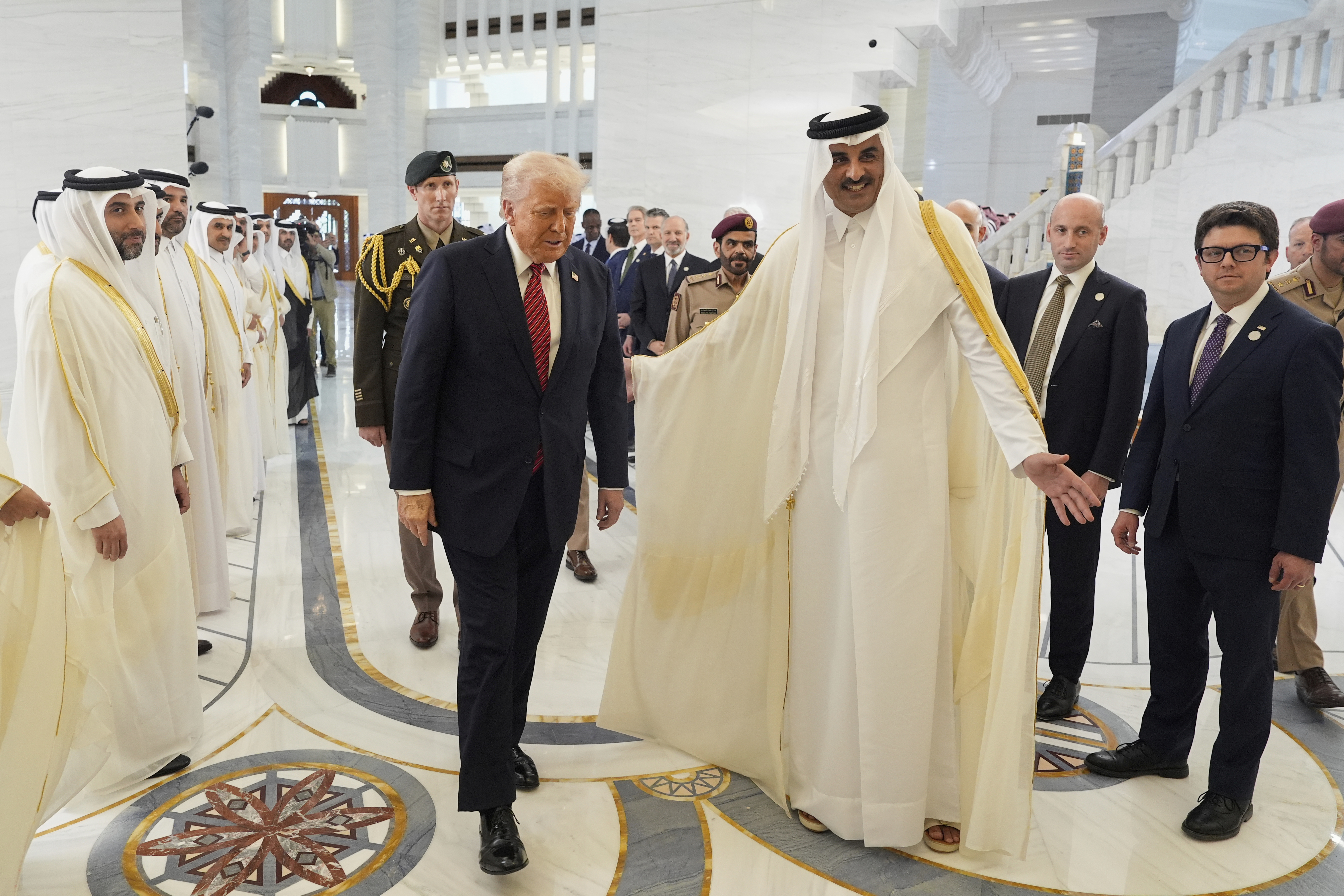 Qatar's Emir Sheikh Tamim bin Hamad Al Thani welcomes President Donald Trump during an official welcoming ceremony at the Amiri Diwan in Doha, Qatar, Wednesday, May 14, 2025. (AP Photo/Alex Brandon)