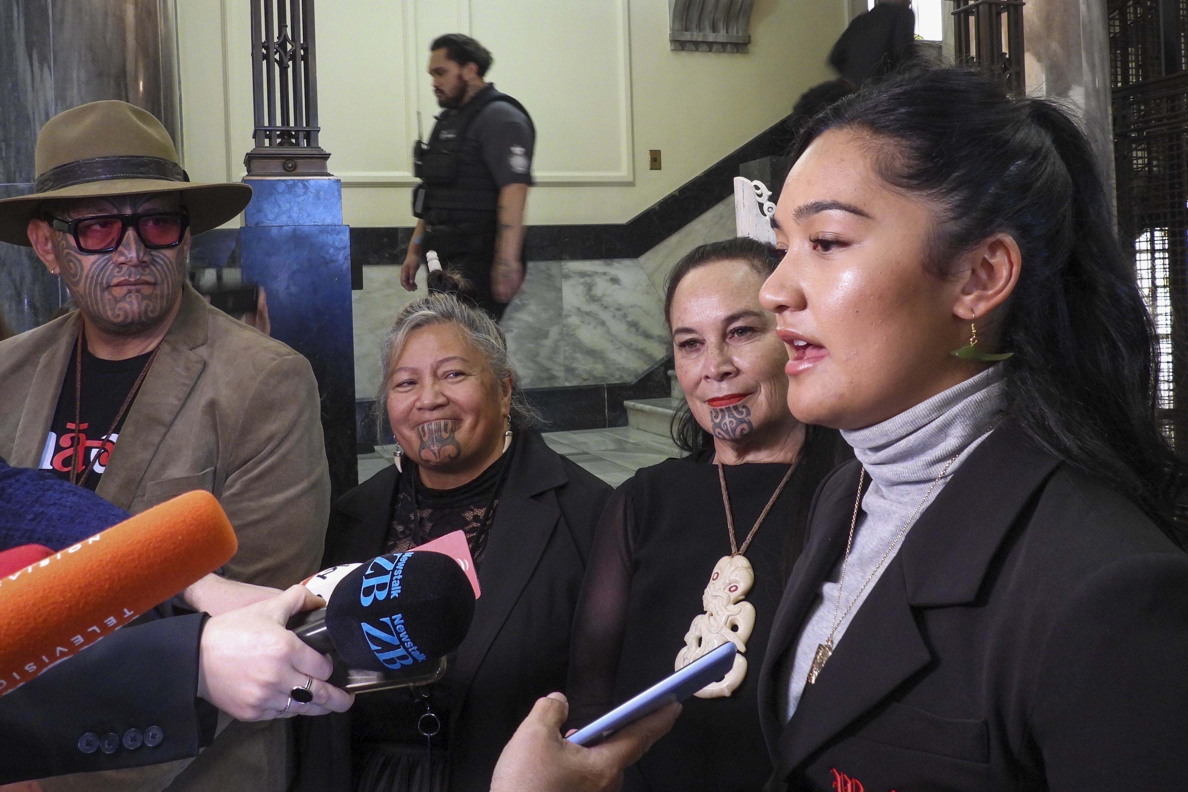 FILE -Hana-Rawhiti Maipi-Clarke, right, and her colleagues from Te Pāti Māori, talk to reporters following a protest inside Parliament in Wellington, New Zealand, Thursday, Nov. 14, 2024. (AP Photo/Charlotte Graham-McLay, File)