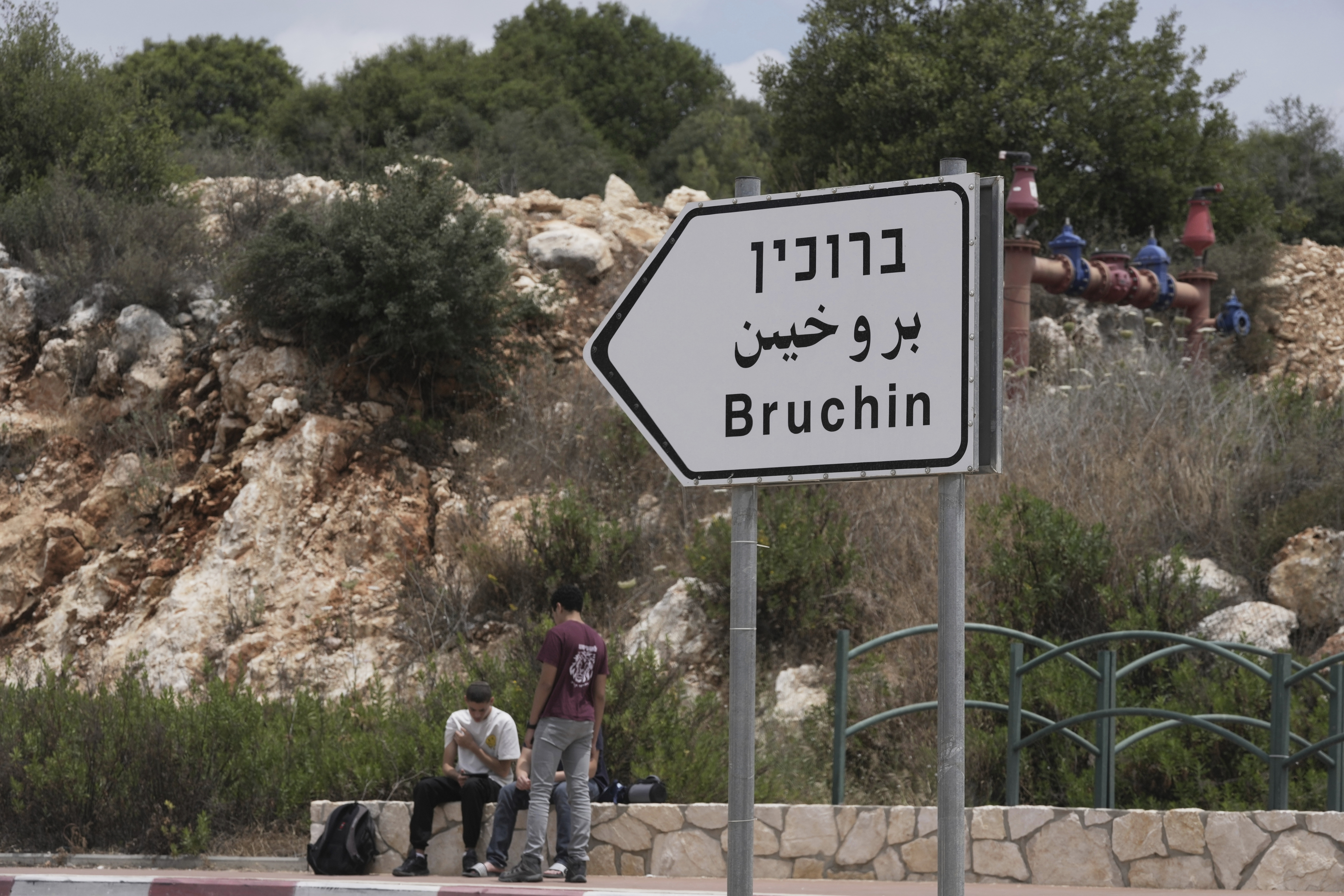 Young Israeli settlers sit outside of the West Bank settlement of Bruchin, the morning after a Palestinian gunman shooting killed Tzeela Gez, who was on her way to the hospital to give birth, outside of the settlement, Thursday, May 15, 2025. (AP Photo/Maya Alleruzzo)