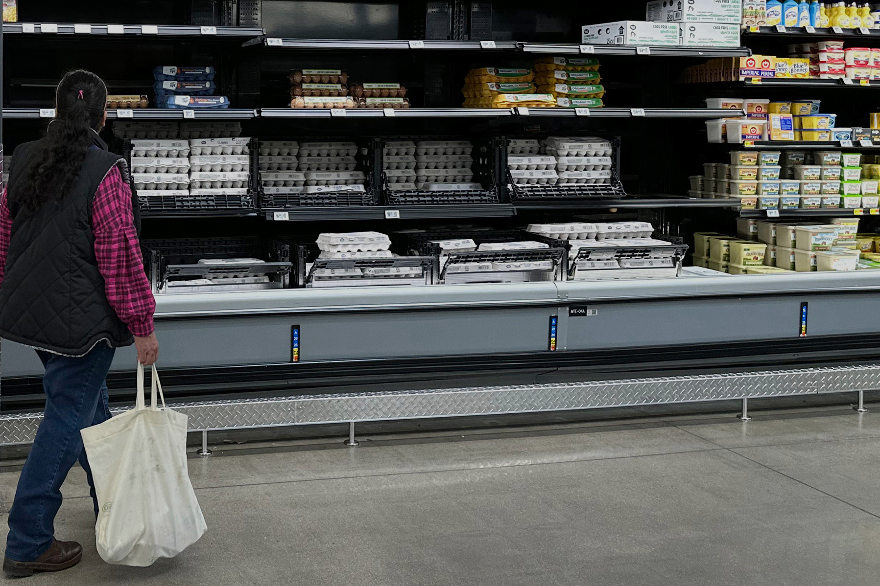 FILE - A shopper passes by the display of cartons of eggs in a Walmart store Friday, Feb. 7, 2025, in Englewood, Colo. (AP Photo/David Zalubowski, File)
