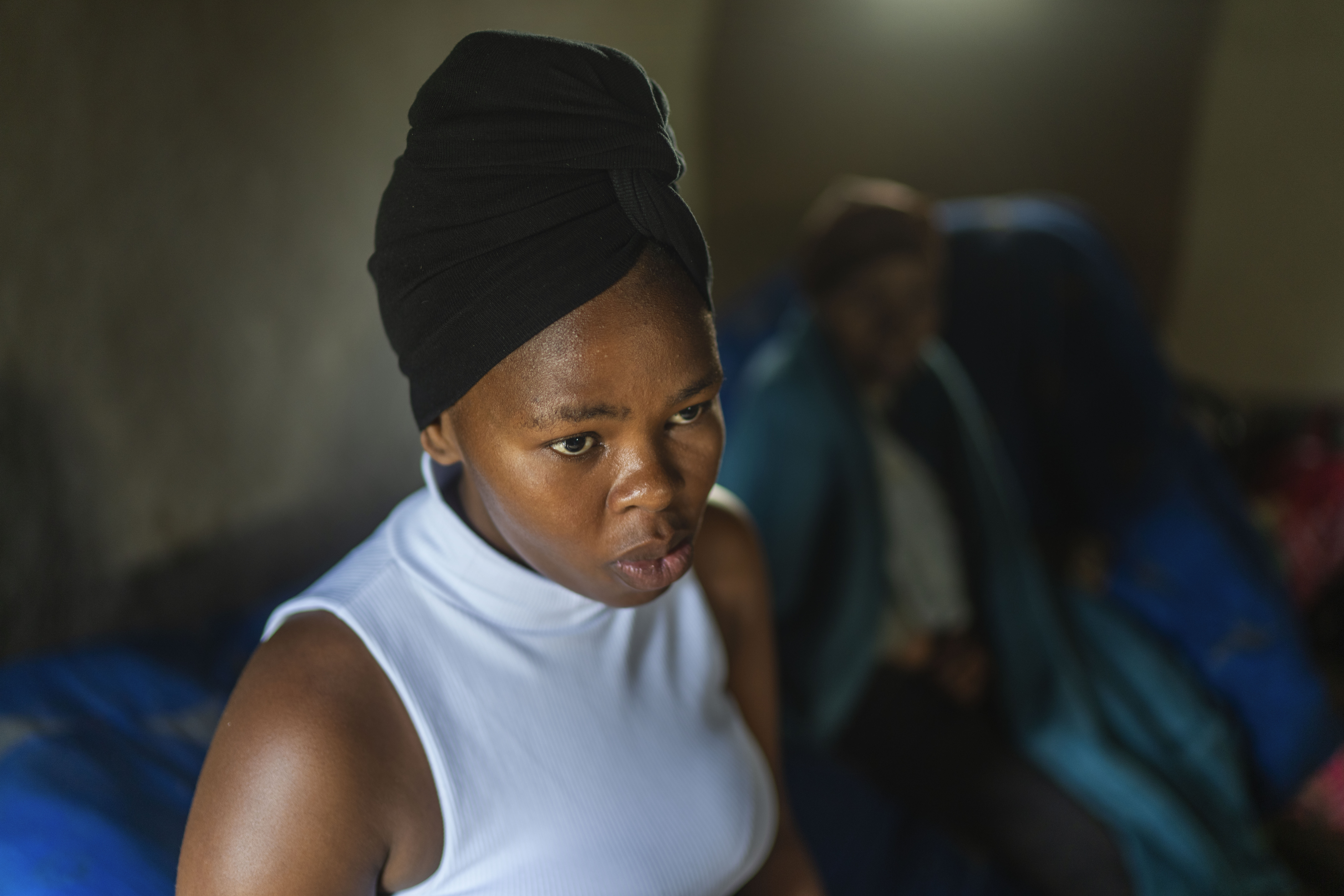Nozuko Majola sits in her Umzimkhulu home,, Nov. 11, 2025 in South Africa. Majola is one of millions of patients in South Africa affected by U.S. President Donald Trump's global foreign aid freeze, raising worries about HIV patients defaulting on treatment. (AP Photo/Jerome Delay, file)