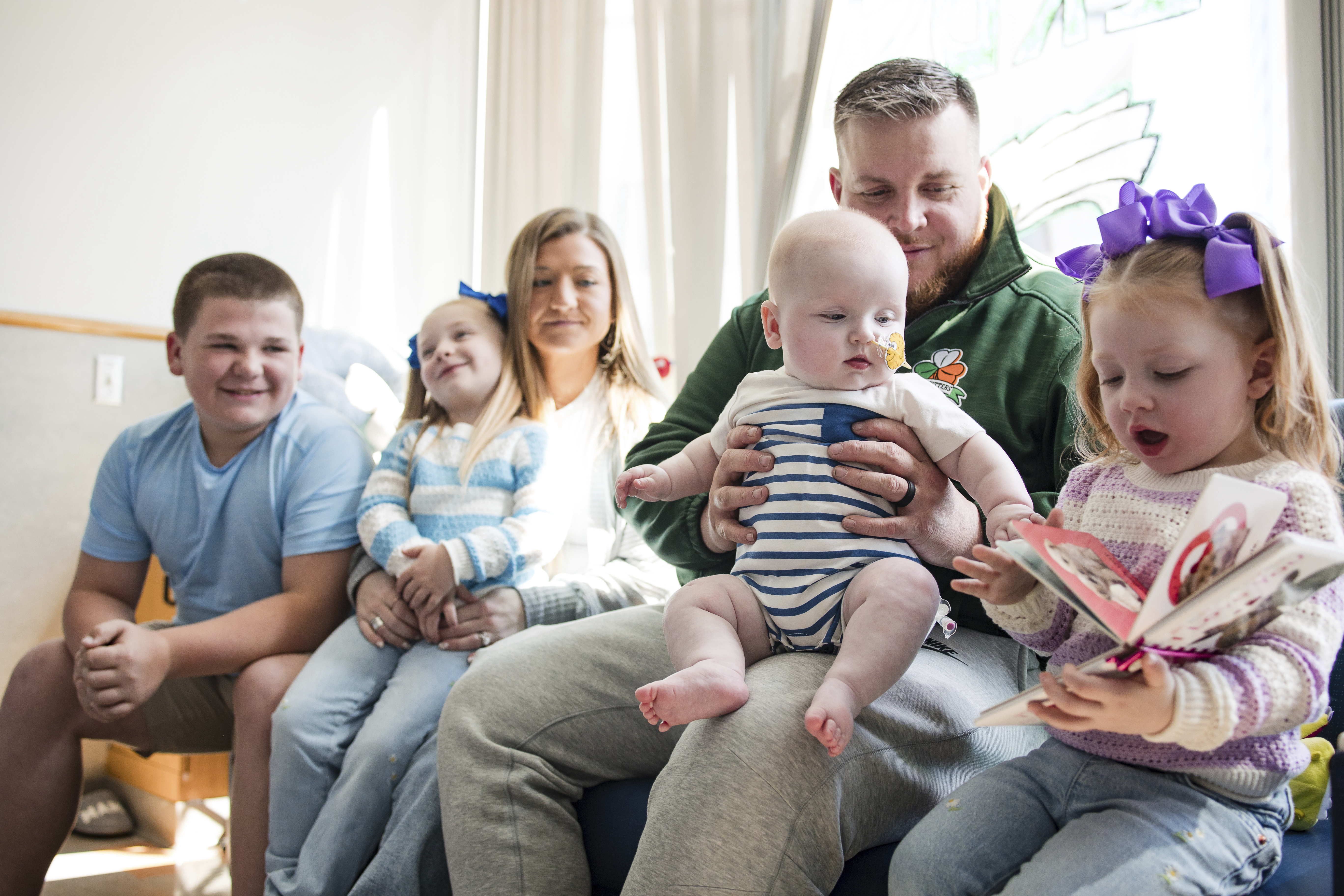In this photo provided by the Children's Hospital of Philadelphia, KJ Muldoon sits with his parents, Kyle and Nicole Muldoon, and his siblings after a follow up dose of an experimental gene editing treatment at the hospital in April 2025. (Chloe Dawson/Children's Hospital of Philadelphia via AP)