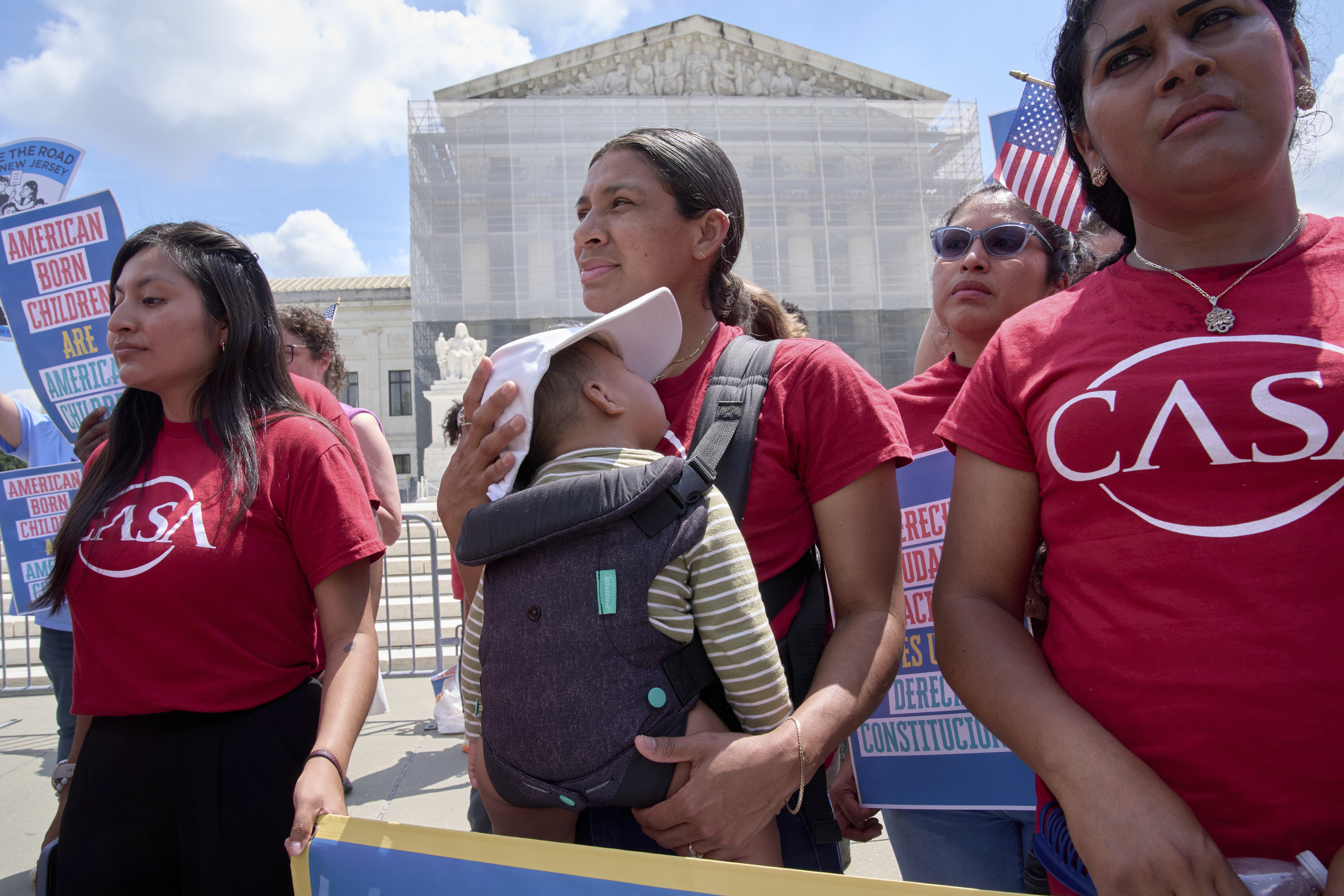 A woman from CASA Maryland holds her 9-month-old baby as she joins others in support of birthright citizenship, Thursday, May 15, 2025, outside of the Supreme Court in Washington. (AP Photo/Jacquelyn Martin)