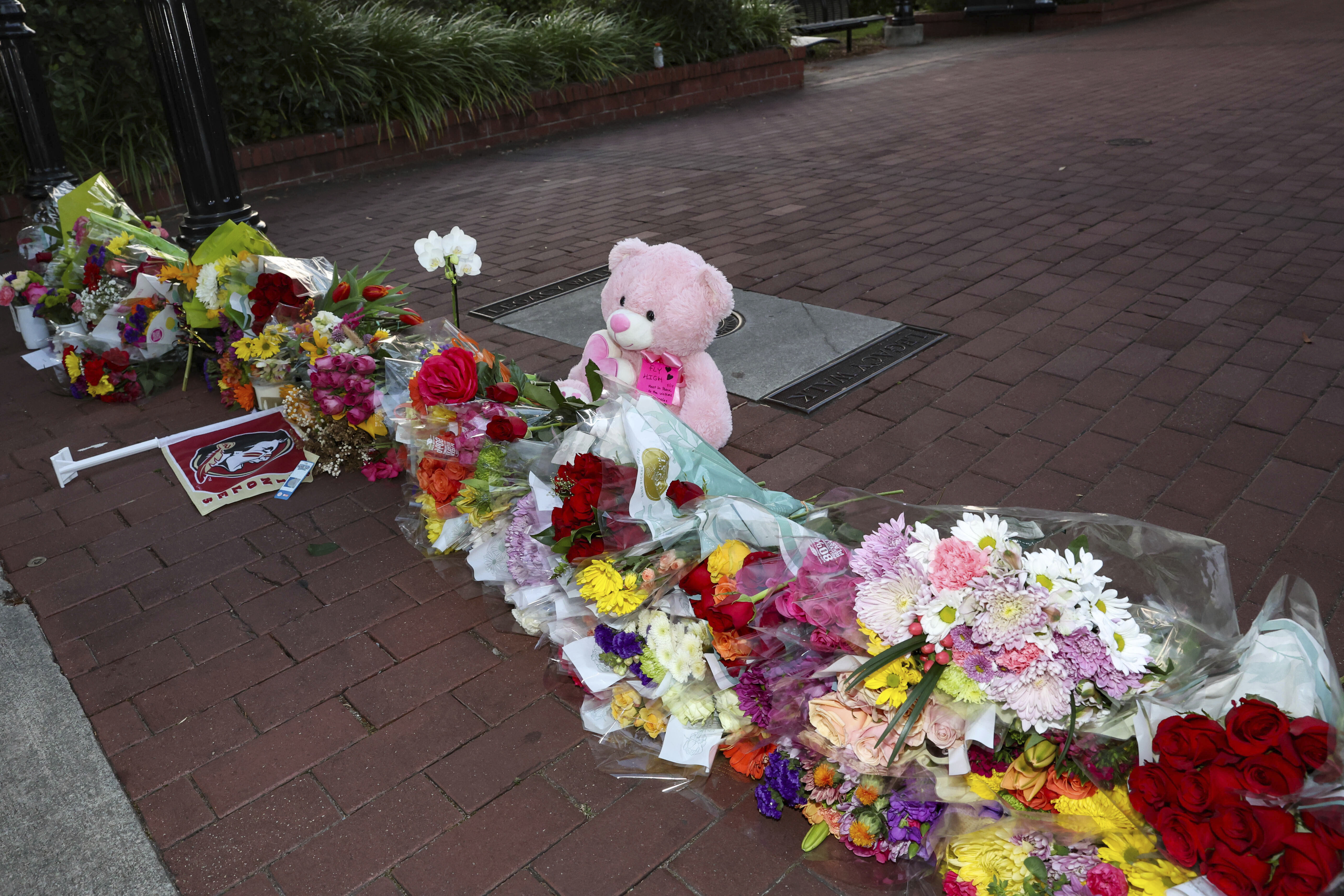 An impromptu memorial of flowers and other items laid near the center of the Florida State campus in sight of the Student Union building, Tallahassee, Fla., Thursday, April 17, 2025. (AP Photo/Gary McCullough)