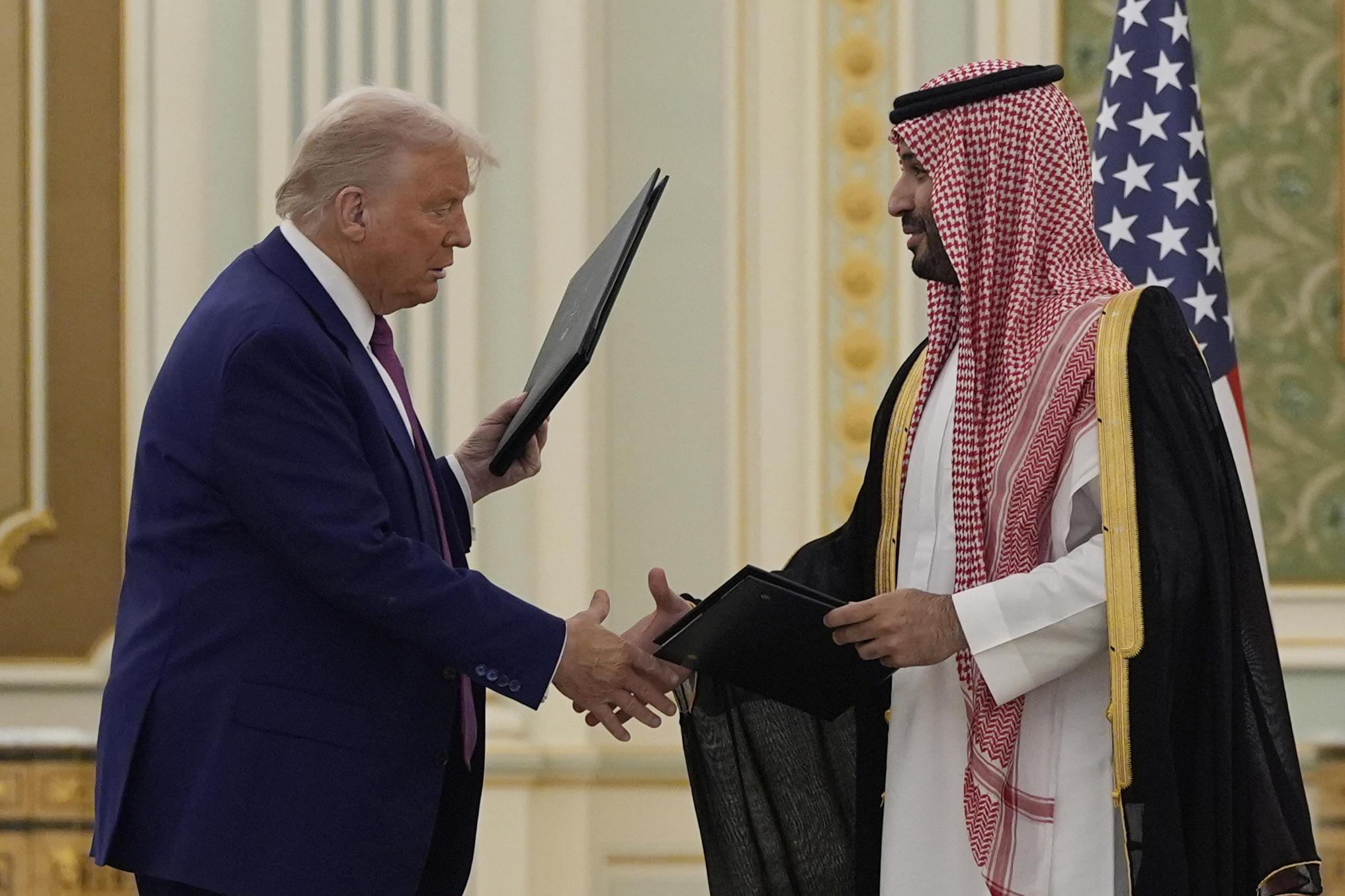President Donald Trump and Saudi Crown Prince Mohammed bin Salman shake hands after exchanging documents during a signing ceremony at the Royal Palace in Riyadh, Saudi Arabia, Tuesday, May 13, 2025. (AP Photo/Alex Brandon)