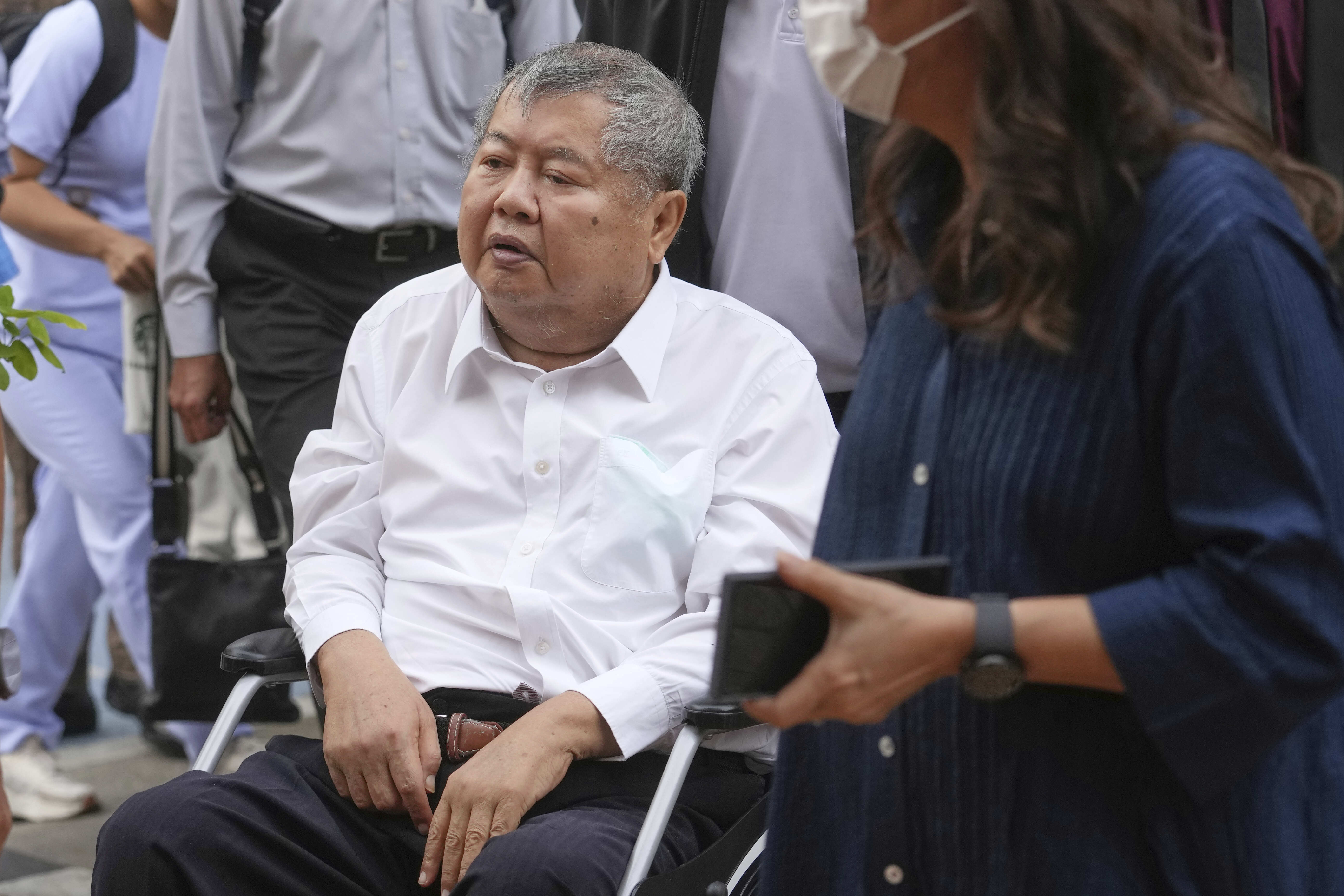 Premchai Karnasuta, the president of Italian-Thai Development Co arrives on a wheelchair at Bang Sue Police Station in Bangkok, Thailand, Friday, May 16, 2025 to surrender to police on criminal negligence charges for the collapse of a Bangkok high-rise during a March 28 earthquake. (AP Photo/Sakchai Lalit)