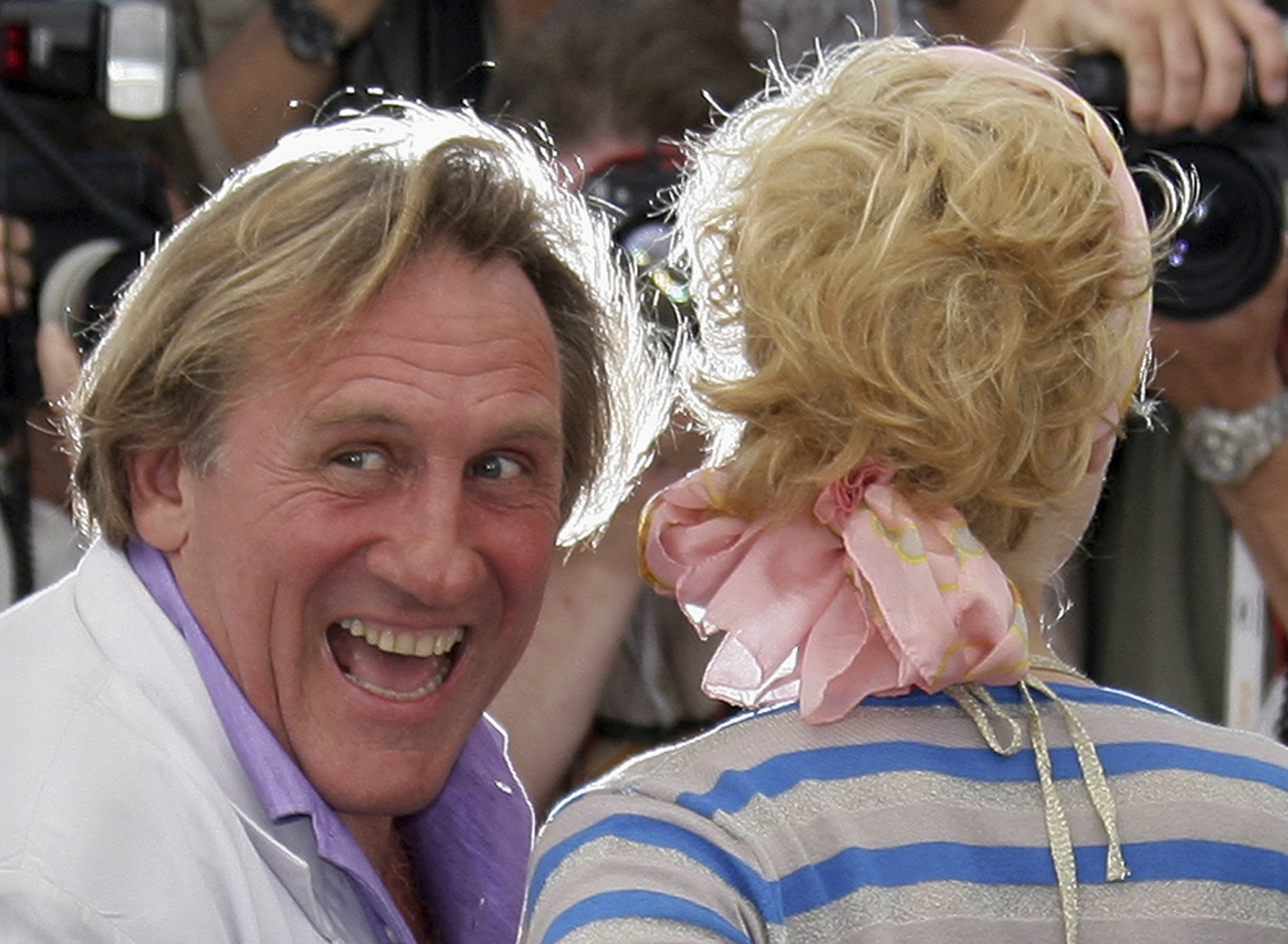 FILE - French actor Gerard Depardieu, left, and Belgian actress Cecile de France pose during a photo call for the film "Quand J'etais Chanteur," at the 59th International film festival in Cannes, southern France, on May 26, 2006. (AP Photo/Francois Mori, File)