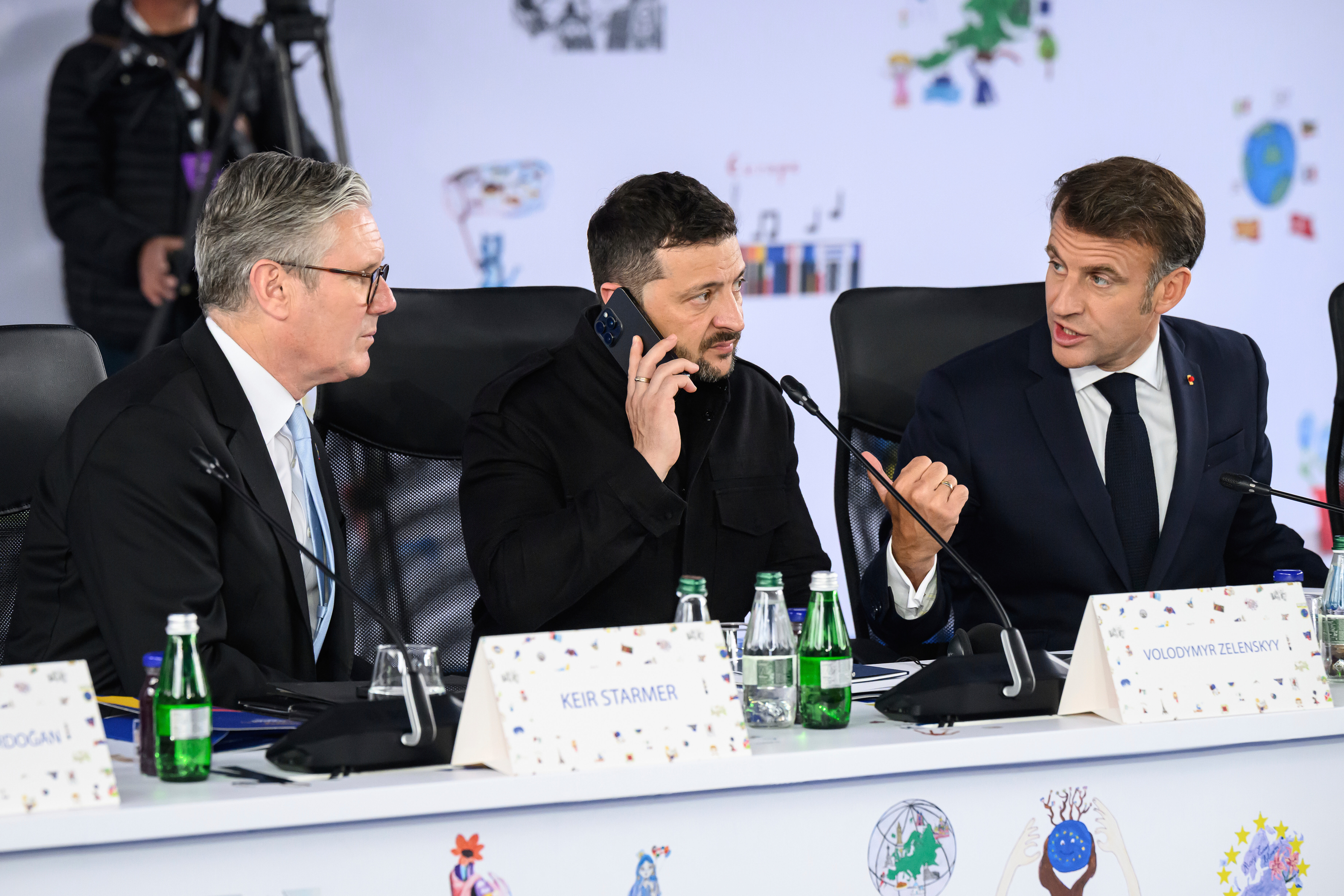 Britain's Prime Minister Keir Starmer, left, Ukraine's President Volodymyr Zelenskyy and France's President Emmanuel Macron, right, attend a plenary meeting at the beginning of a summit where the leaders of 47 European countries and organizations will discuss security, defense and democratic standards, in Tirana, Albania, Friday, May 16, 2025. (Leon Neal/Pool via AP)