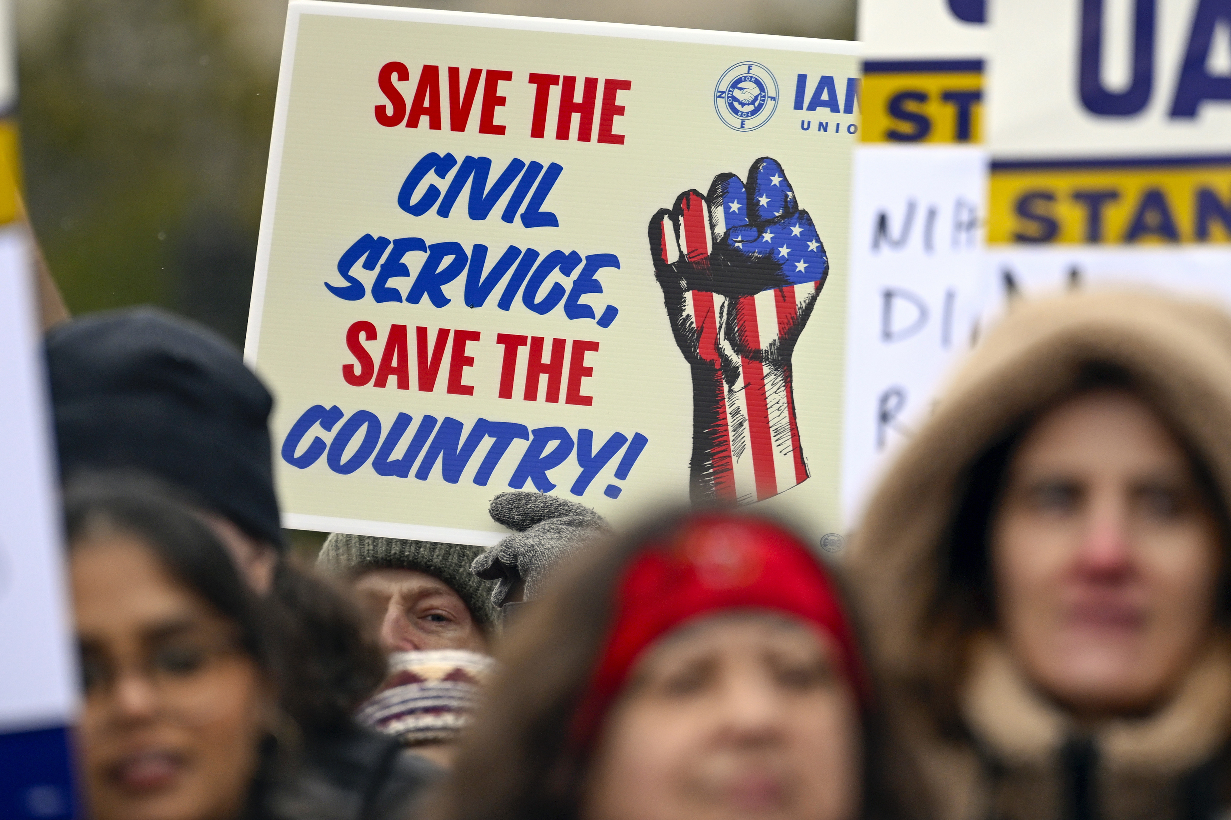 FILE - People rally at Health and Human Services headquarters to protest the polices of President Donald Trump and Elon Musk Wednesday, Feb. 19, 2025, in Washington. (AP Photo/John McDonnell, file)