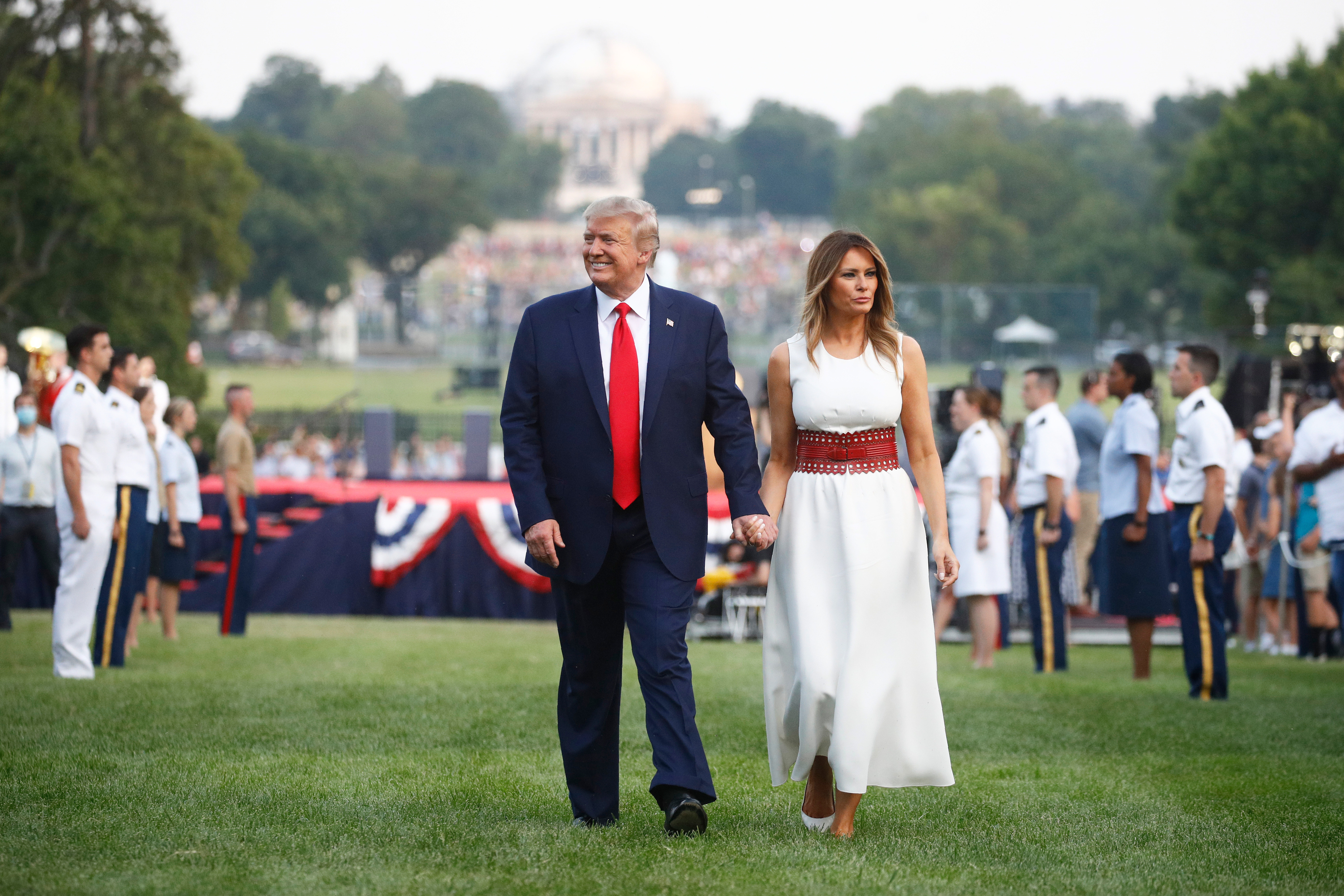 FILE - President Donald Trump and first lady Melania Trump walk on the South Lawn of the White House during a "Salute to America" event, July 4, 2020, in Washington. (AP Photo/Patrick Semansky, File)