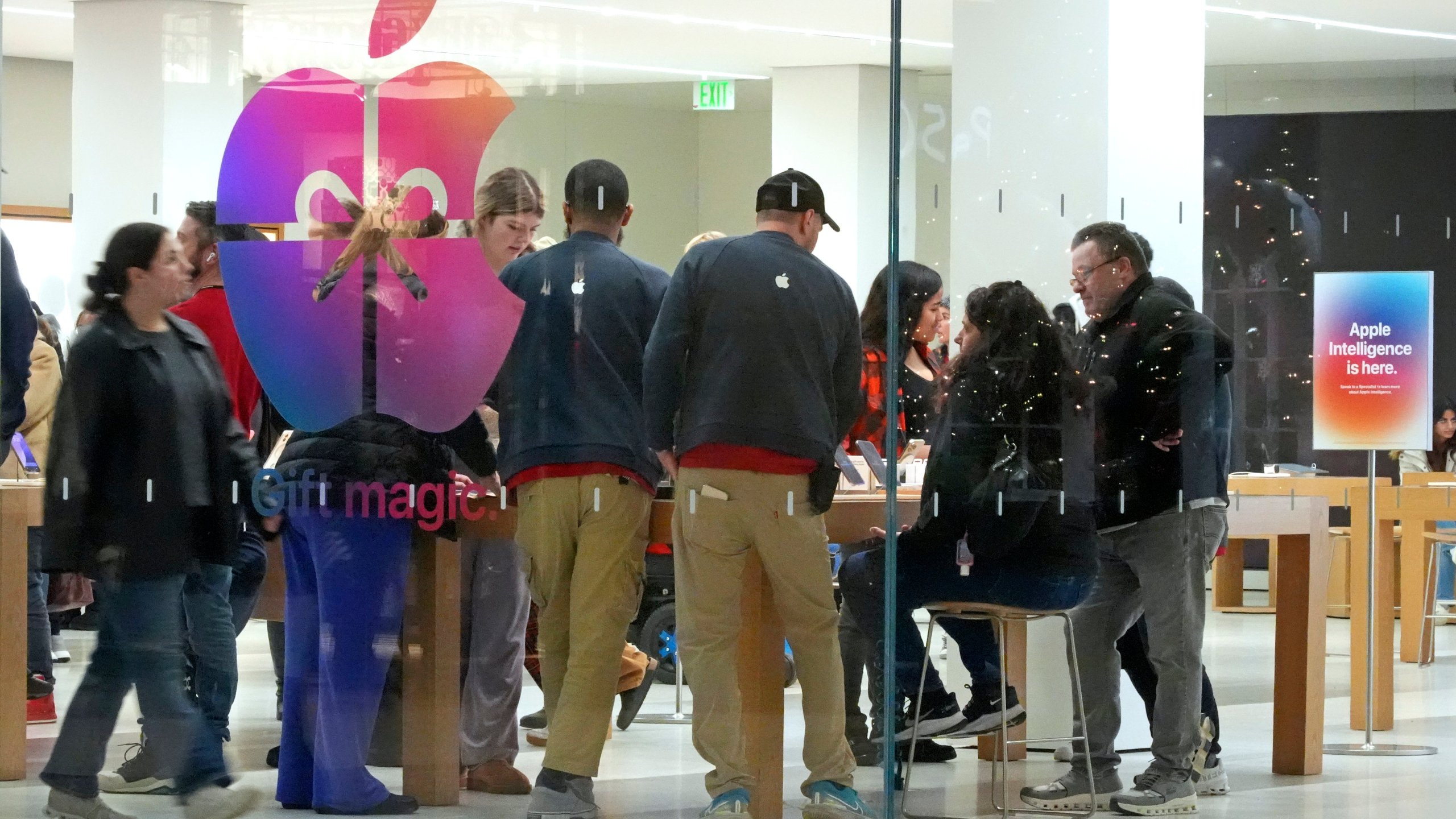 FILE - Shoppers look at Apple products in the Apple Store at the Walden Galleria in Buffalo, NY, on Saturday, Nov. 30, 2024. (AP Photo/Gene J. Puskar, File)