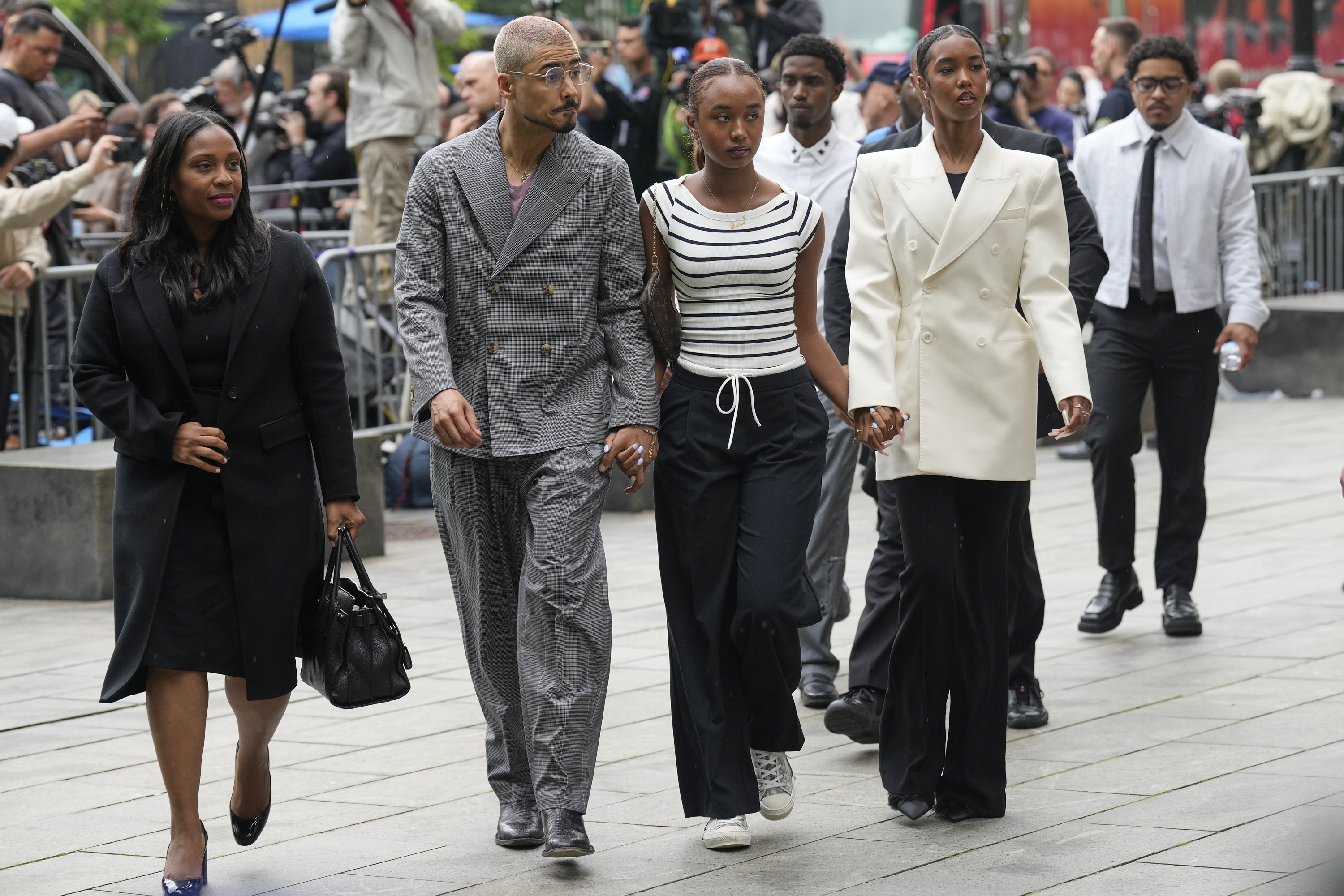 Quincy Combs, second from left, and Chance Combs center, arrive at Manhattan federal court, Tuesday, May 13, 2025, in New York. (AP Photo/Seth Wenig)