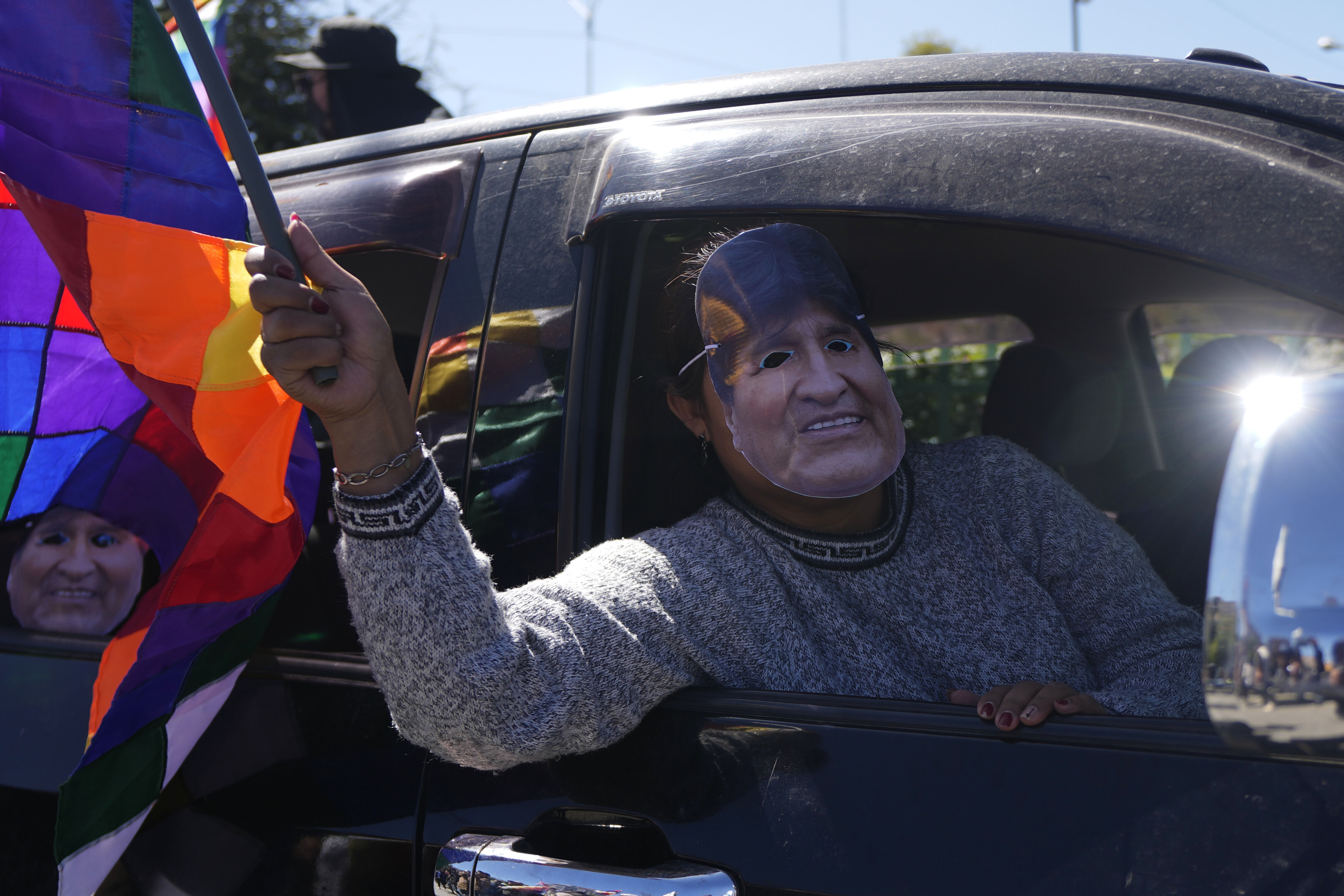 A man wearing a mask depicting former President Evo Morales tales part in a caravan to the Electoral Tribunal offices in El Alto, Bolivia, Friday, May 16, 2025. (AP Photo/Juan Karita)