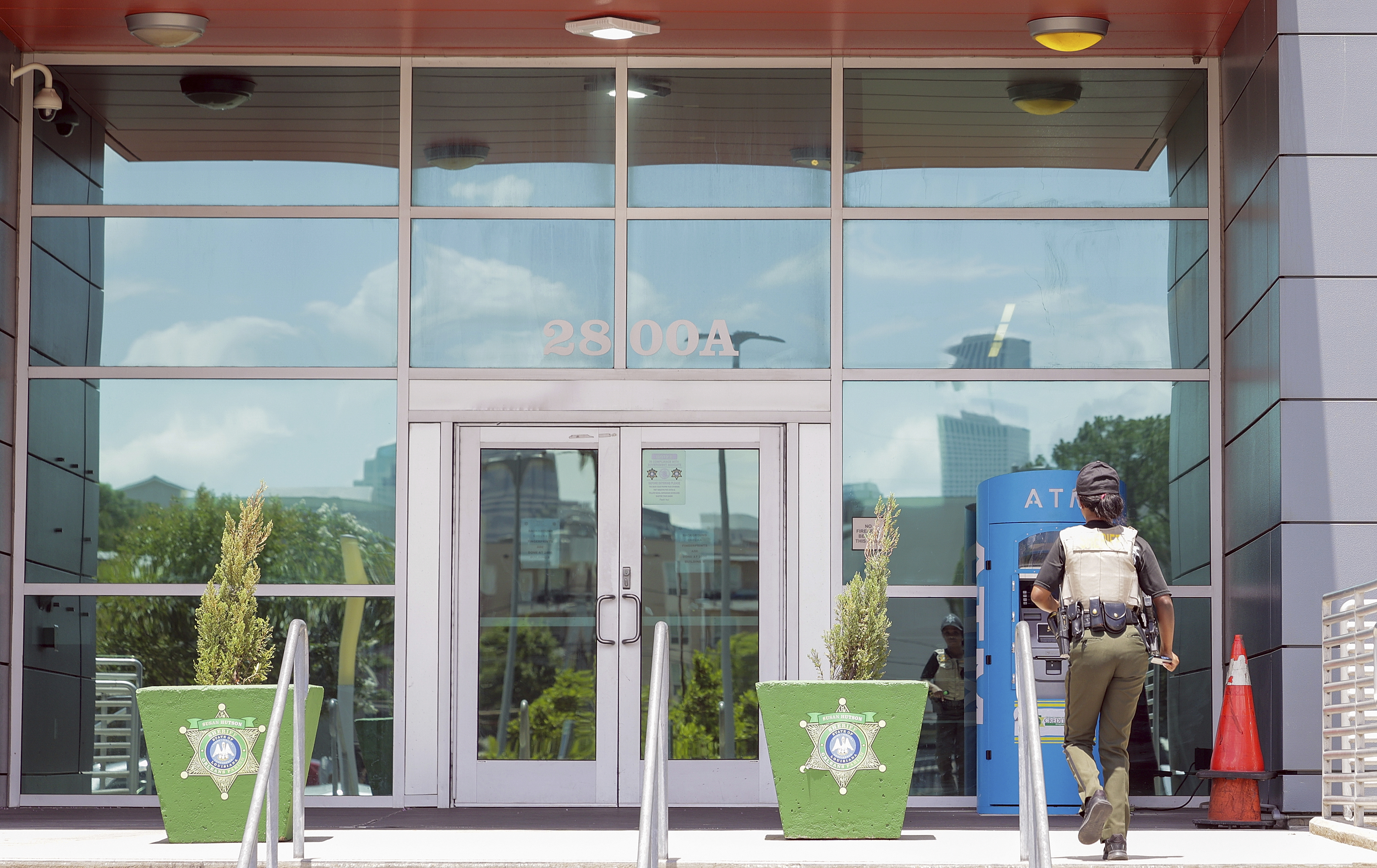 A law enforcement officer enters the Orleans Parish Sheriff's Office in New Orleans on Friday, May 16, 2025. (Brett Duke /The Advocate via AP)