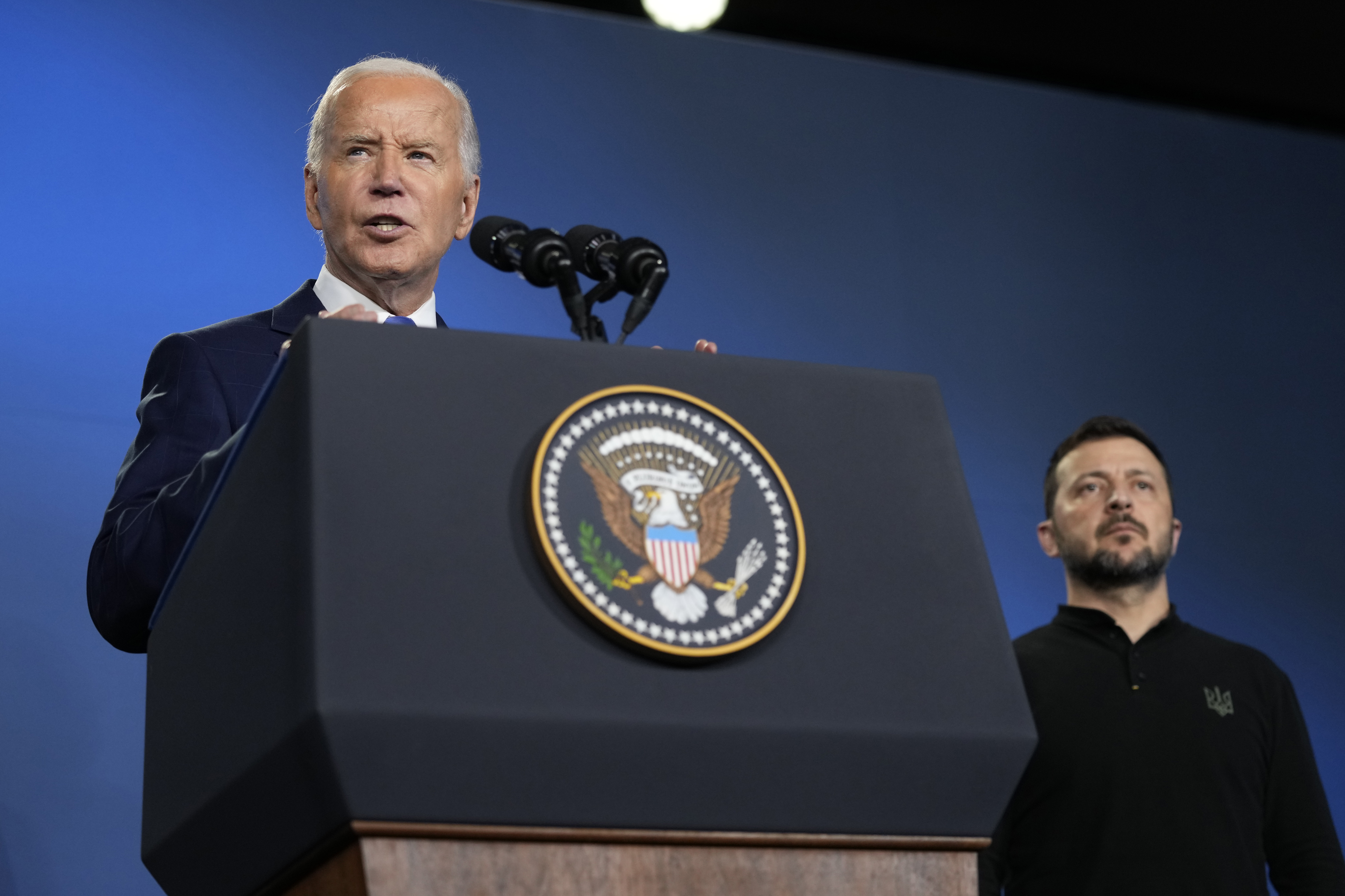 FILE - President Joe Biden, left, joined by President of Ukraine Volodymyr Zelenskyy, speaks during an event on the Ukraine Compact on the sidelines of the NATO Summit in Washington, Thursday, July 11, 2024. (AP Photo/Susan Walsh, File)
