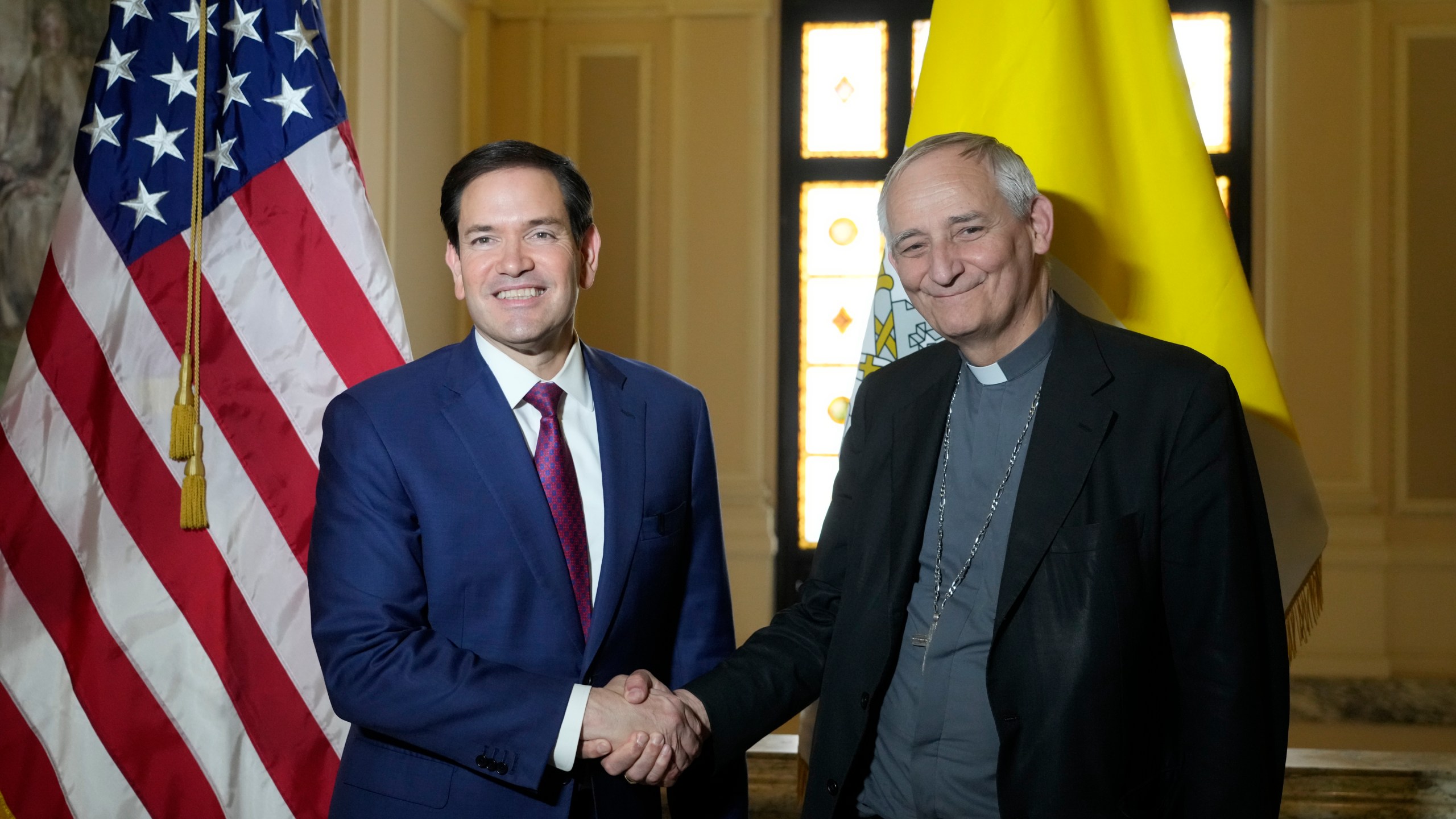 Secretary of State Marco Rubio, left, and President of the Conference of Italian Bishops, Cardinal Matteo Zuppi, pose for a photo at the U.S. Embassy to the Holy See in Rome, Saturday, May 17, 2025. (AP Photo/Gregorio Borgia)