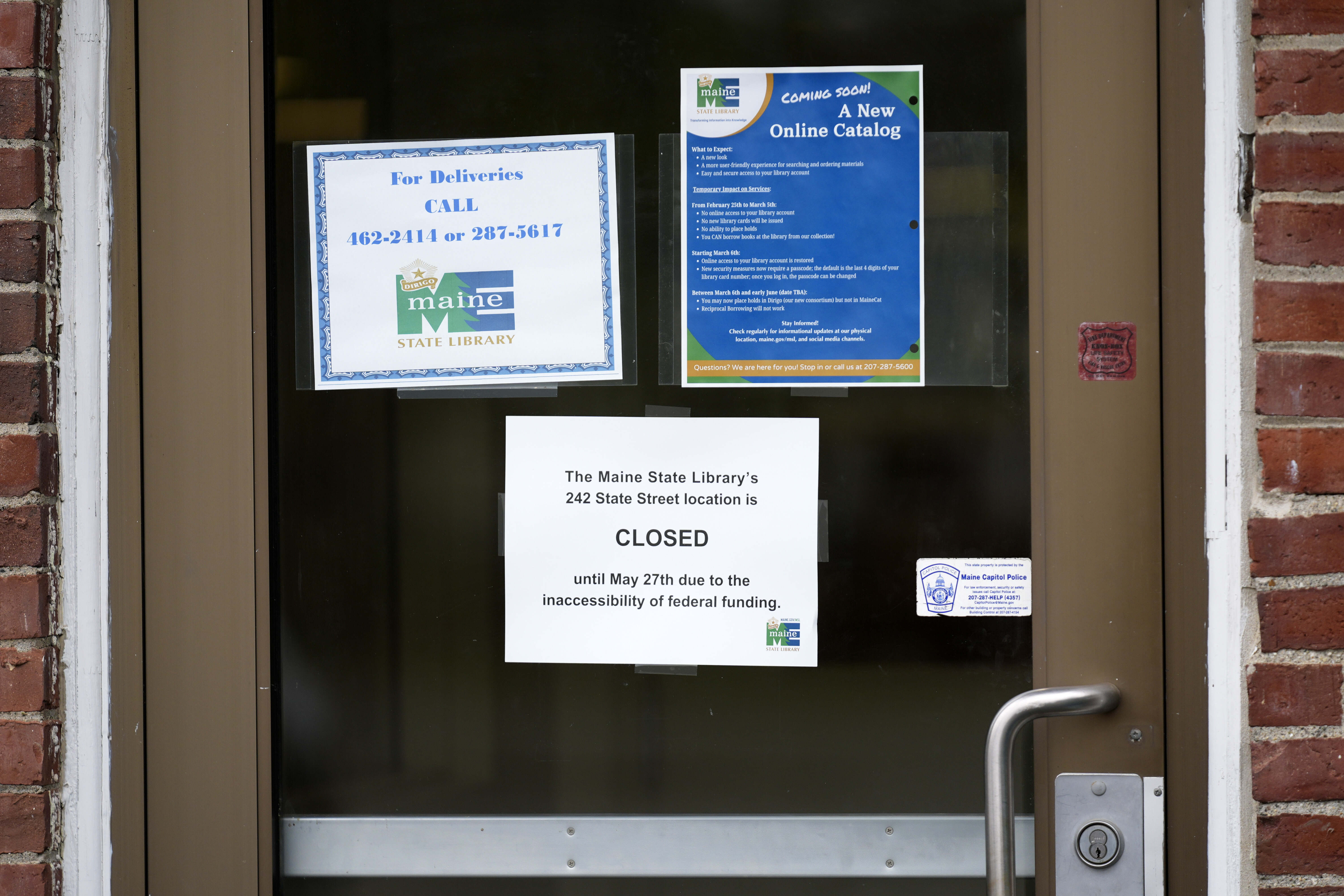 A sign announces the extended closure of the Maine State Library, Wednesday, May 7, 2025, in Augusta, Maine. (AP Photo/Robert F. Bukaty)