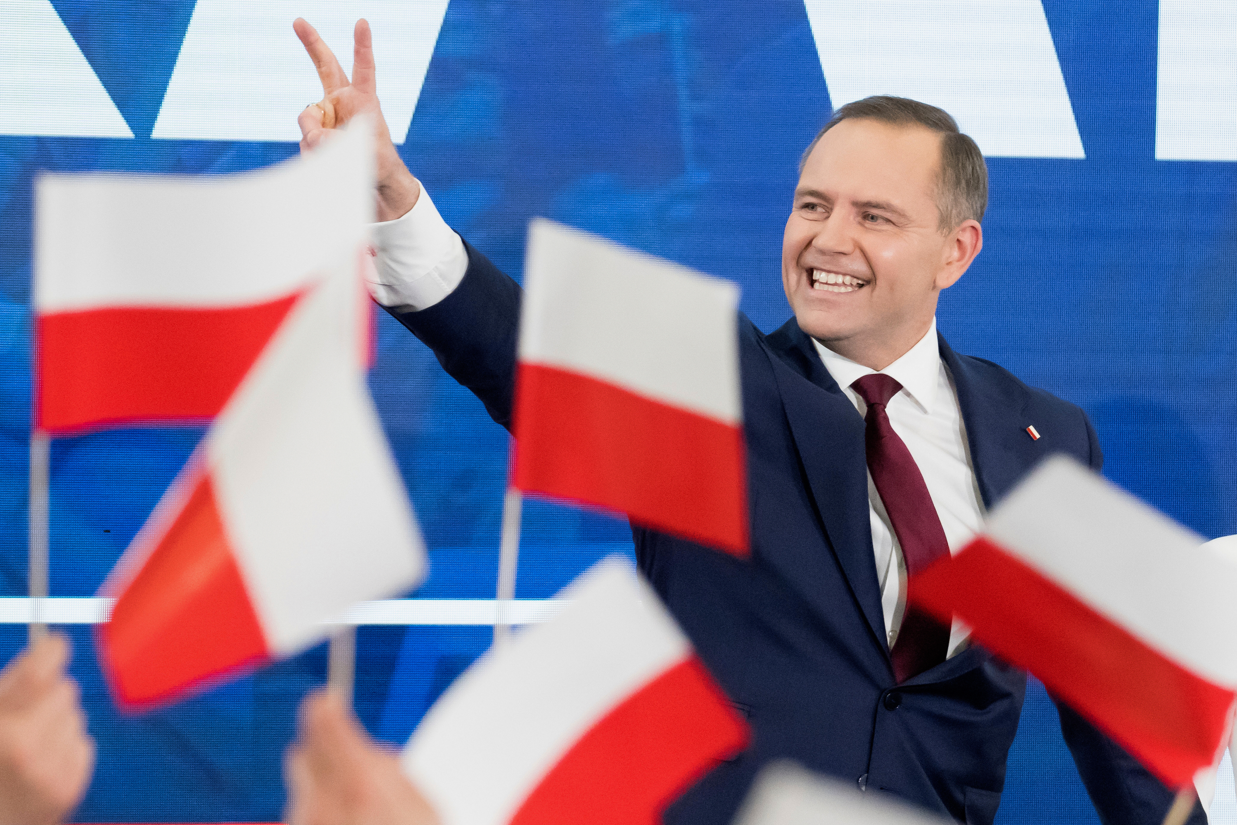 Karol Nawrocki, presidential candidate for the 2025 Polish presidential election supported by Poland's national conservative Law and Justice party, waves to supporters as first exit polls following presidential elections are announced in Gdansk, Poland, Sunday, May 18, 2025. (AP Photo/Wojciech Strozyk)