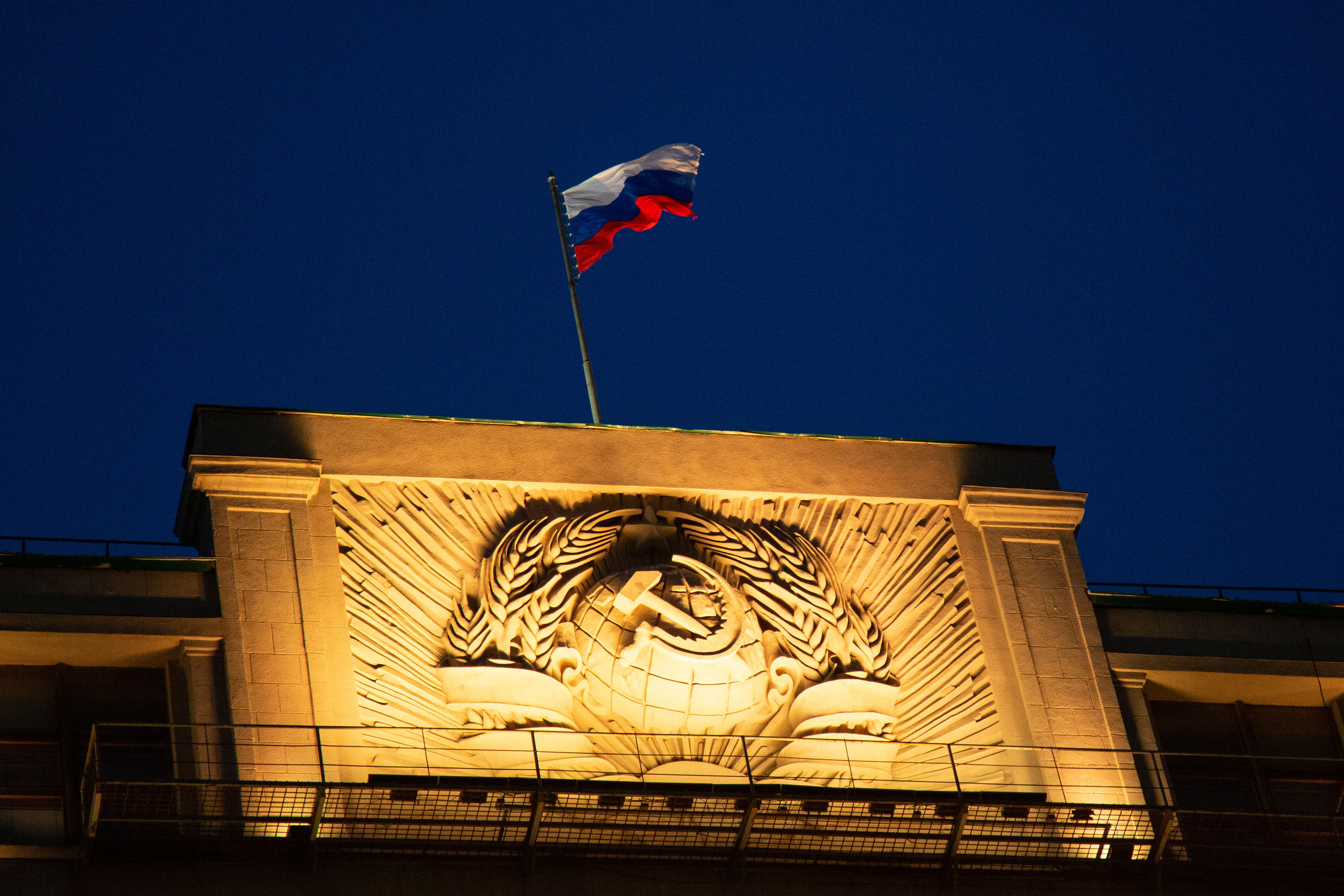 FILE - A Russian state flag waves on top of a hummer and sickle at the State Duma, lower parliament chamber, headquarters in Moscow, Russia, Sunday, March 3, 2019. (AP Photo/Alexander Zemlianichenko, File)