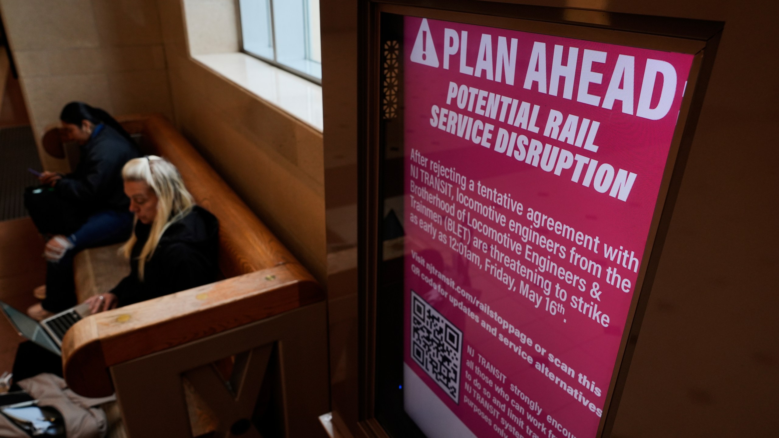 An electronic display advises commuters of potential NJ Transit service disruptions at the Secaucus Junction station in Secaucus, N.J., Wednesday, May 14, 2025. (AP Photo/Seth Wenig)