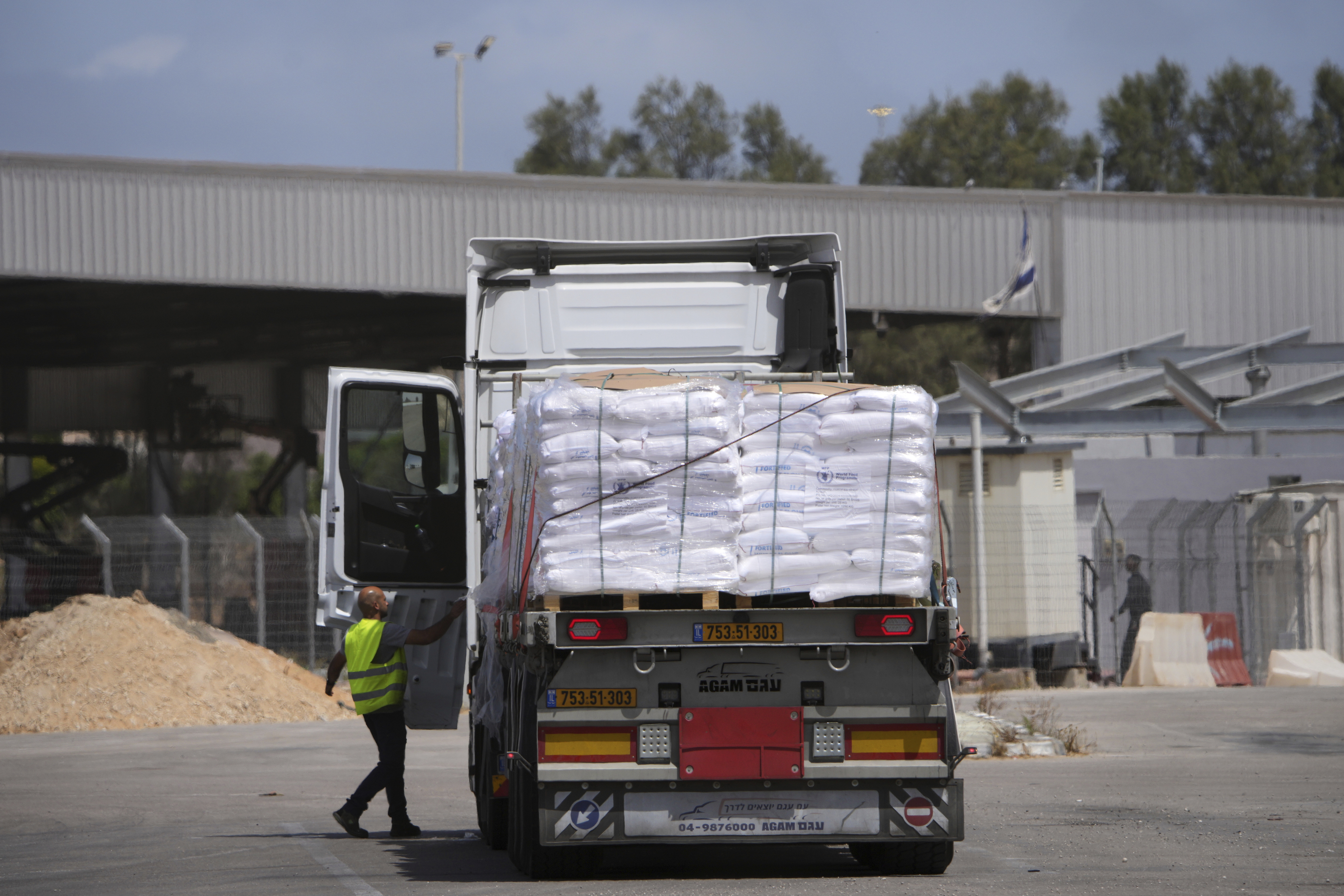 Trucks carrying humanitarian aid for the Gaza Strip are seen at the Kerem Shalom Crossing in southern Israel, Monday, May 19, 2025. A day after Israel said it would resume allowing aid into the territory. (AP Photo/Ohad Zwigenberg)