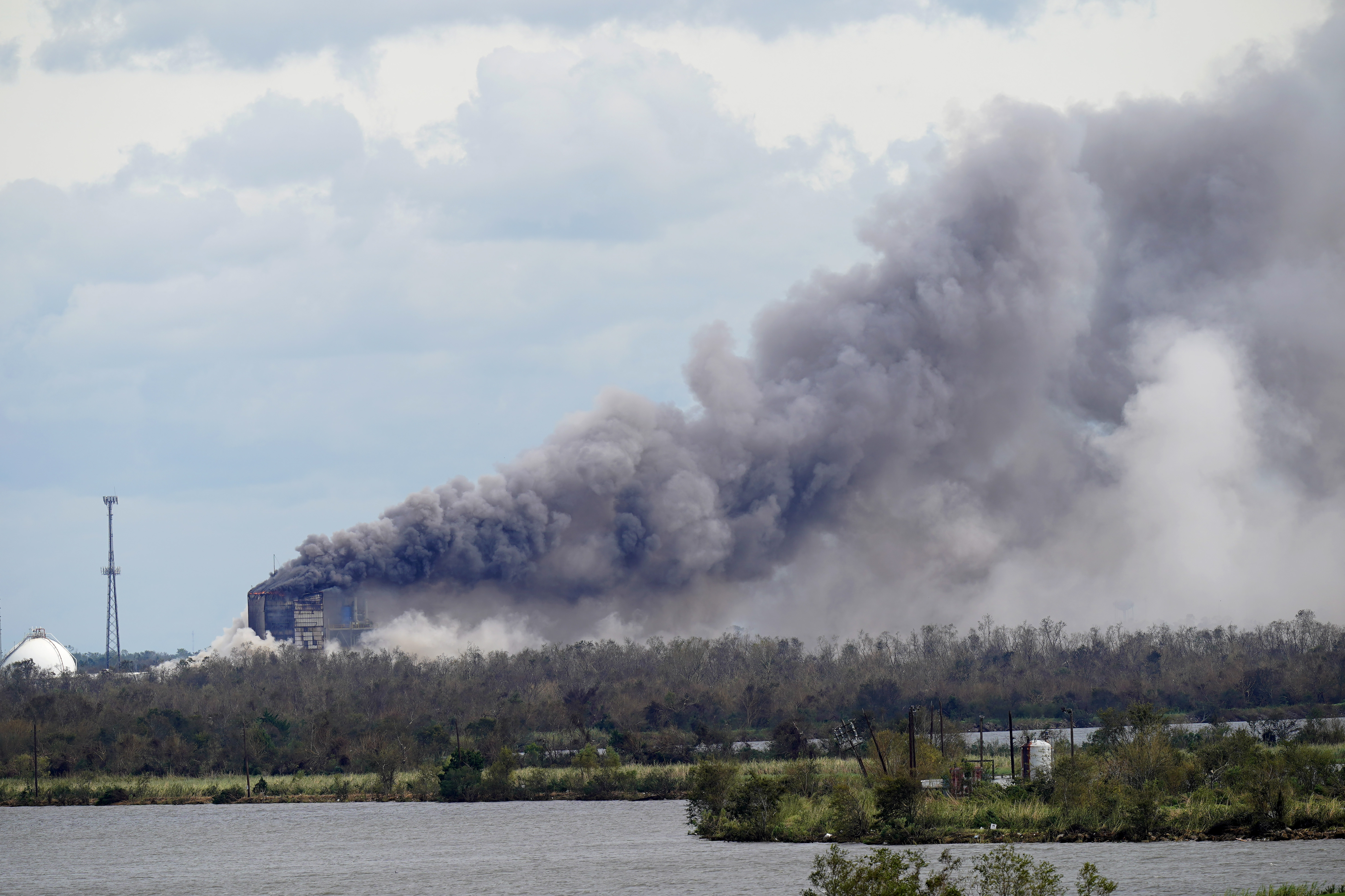 FILE - A fire at a chemical plant, BioLab Inc., that handles chlorine for swimming pools burns on Thursday, Aug. 27, 2020, in Westlake, La., in the aftermath of Hurricane Laura. (AP Photo/Gerald Herbert, file)