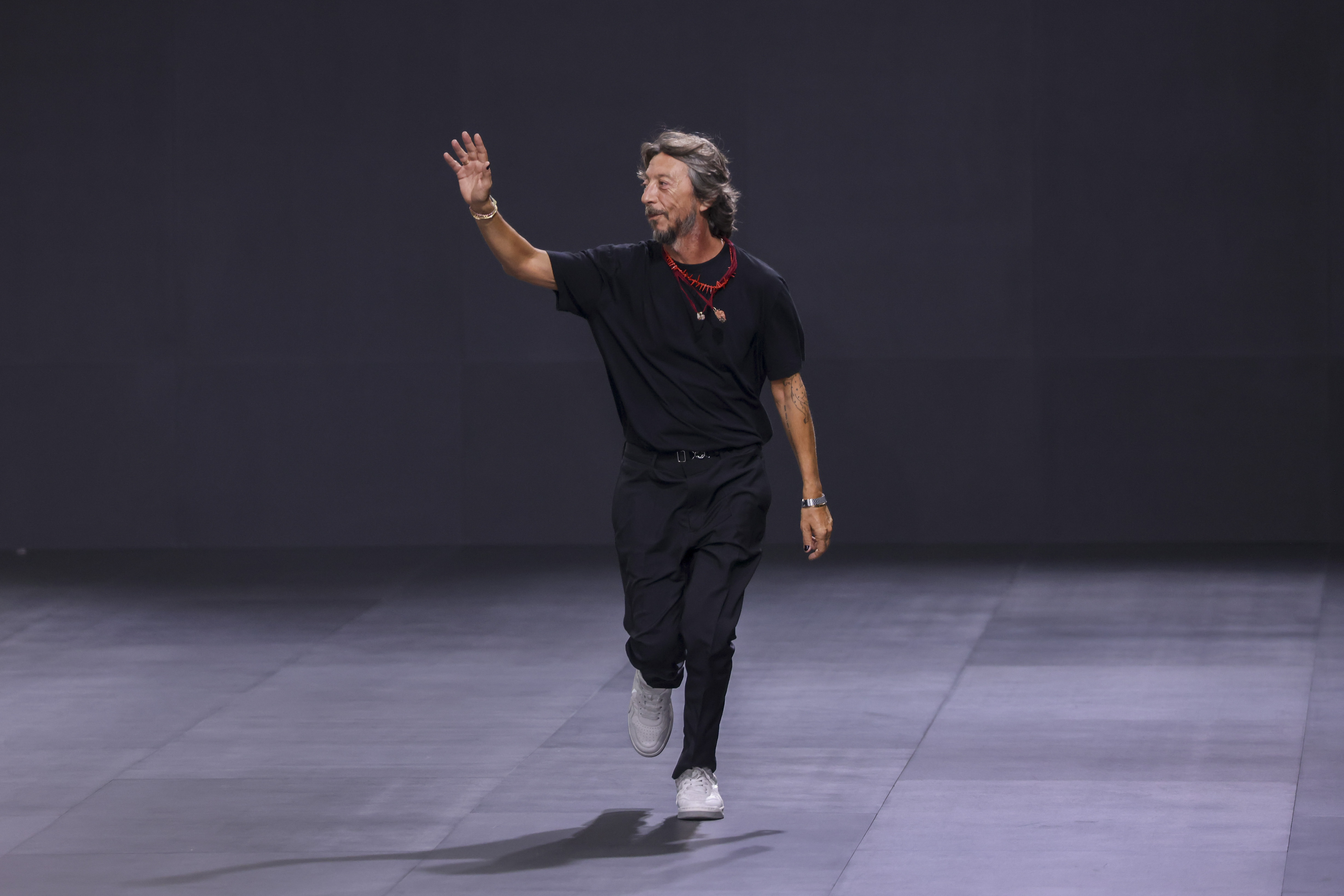 FILE - Pierpaolo Piccioli receives applause at the end of the Valentino ready-to-wear Spring/Summer 2023 fashion collection presented Sunday, Oct. 2, 2022 in Paris. (Photo by Vianney Le Caer/Invision/AP, File)