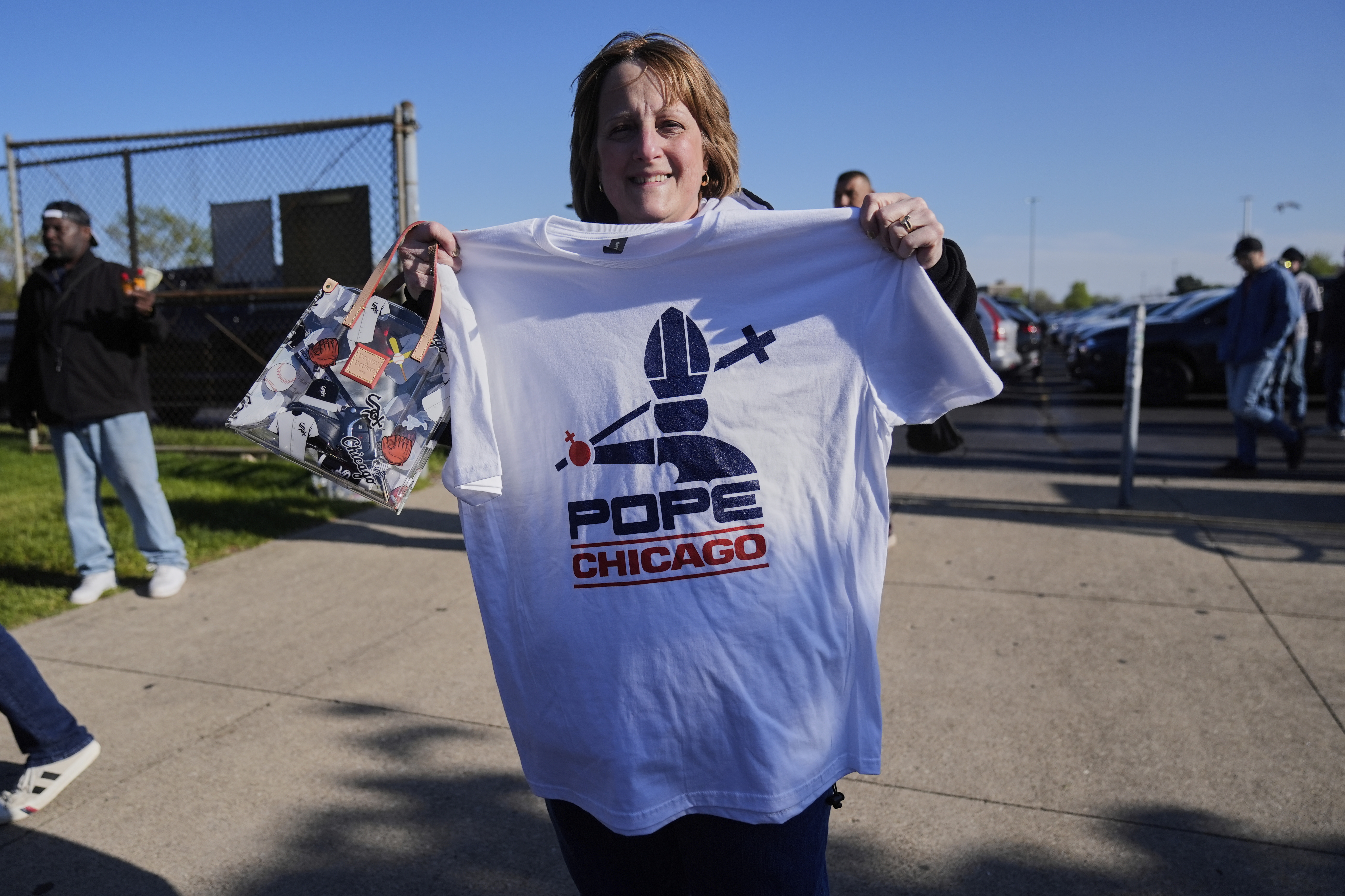 Sue Rosinski holds a Pope Leo XIV-themed shirt she bought outside Rate Field before a baseball game between the Chicago White Sox and Miami Marlins, Saturday, May 10, 2025, in Chicago. (AP Photo/Erin Hooley)