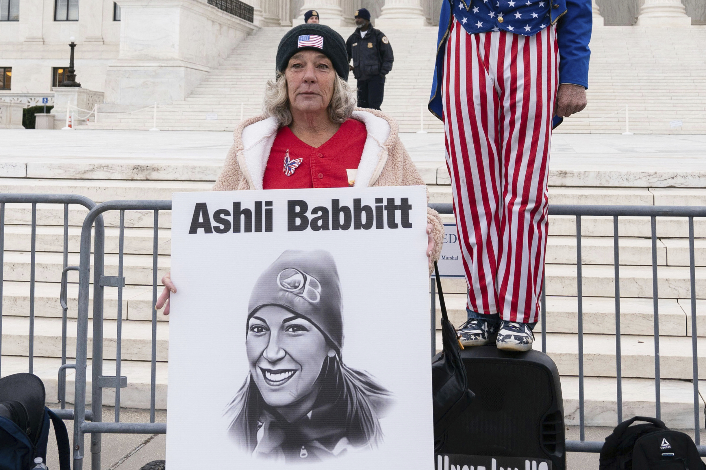 FILE - Micki Witthoeft, center, mother of Ashli Babbitt, the woman fatally shot by police inside the U.S. Capitol during the Jan. 6, 2021, riot, joins protesters outside of the Supreme Court on the second anniversary of the Jan. 6, assault on the U.S. Capitol, in Washington, Jan. 6, 2023. (AP Photo/Jose Luis Magana)
