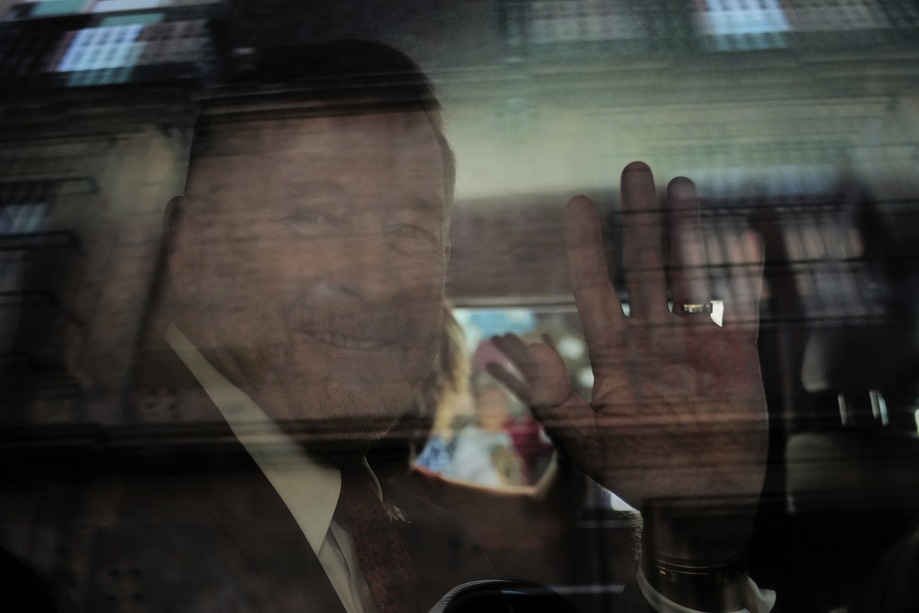 FILE - New U.S. Ambassador to Mexico Ronald Johnson waves from the inside of a vehicle while leaving the National Palace after a meeting with Mexico's President Claudia Sheinbaum in Mexico City, Monday, May 19, 2025. (AP Photo/Marco Ugarte,File)