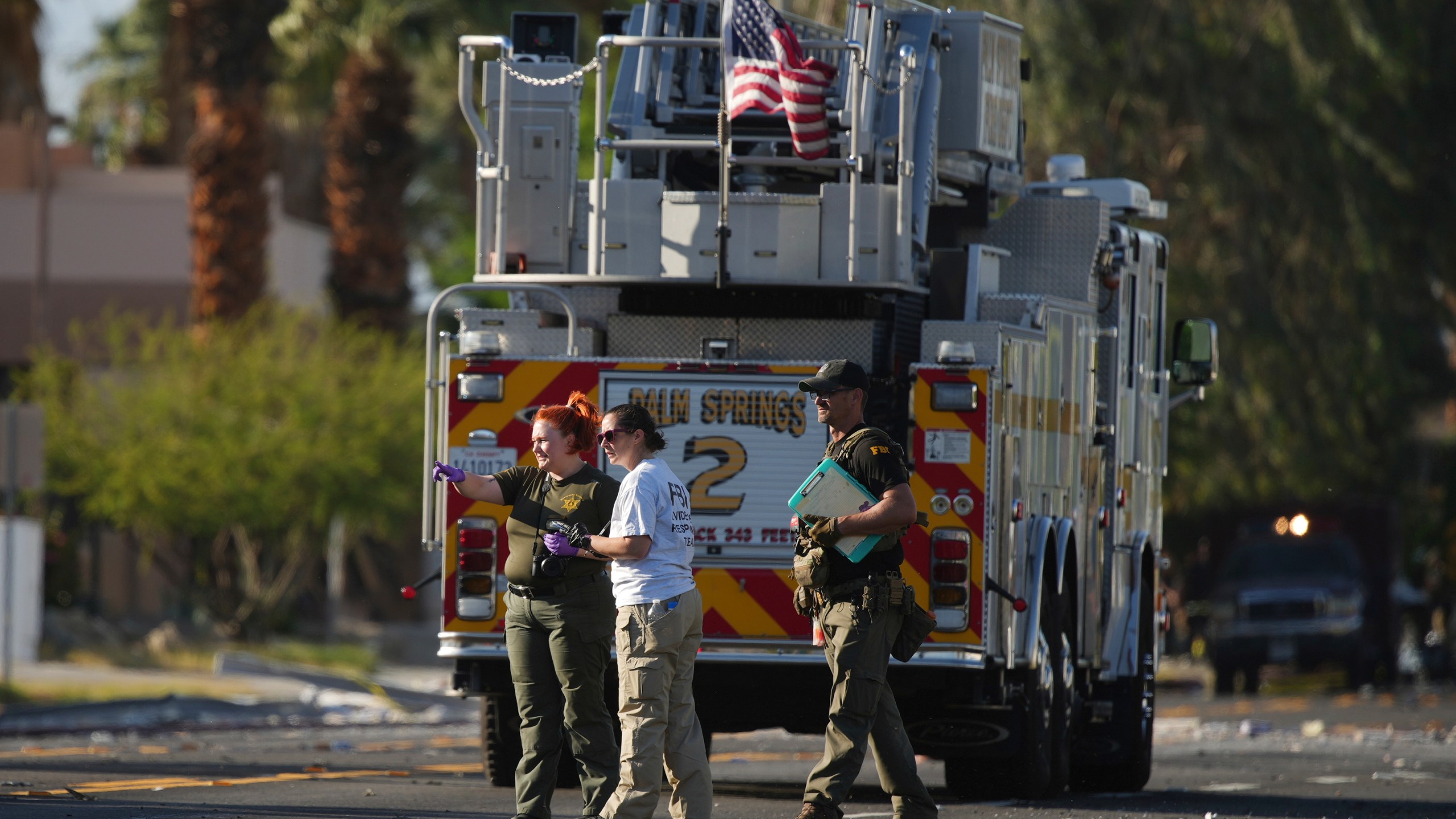 Investigators walk the on the scene of an explosion Saturday, May 17, 2025, in Palm Springs, Calif. (AP Photo/Eric Thayer)