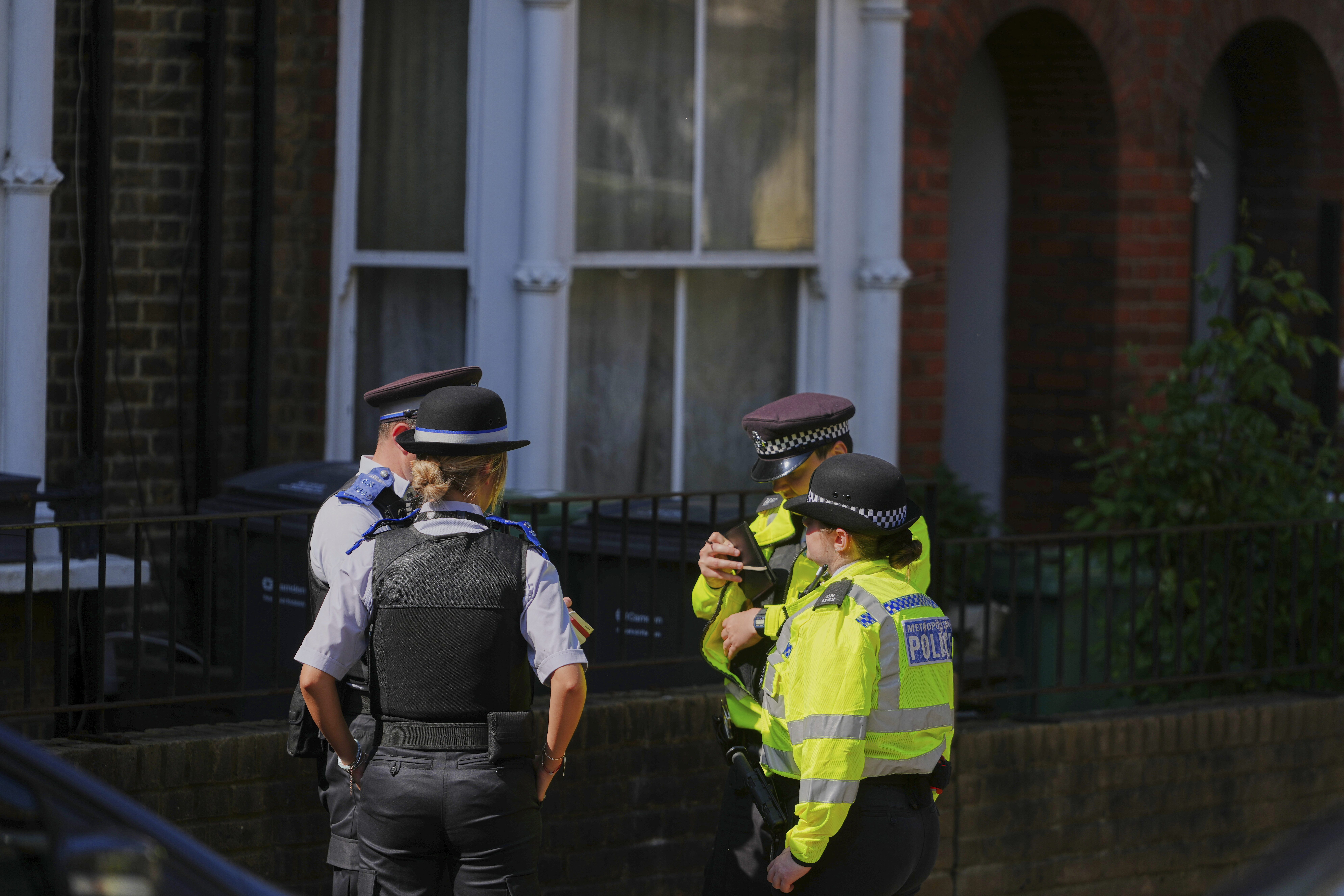 Police Community Support Officers and Police Officers stand on the street near a house belonging to British Prime Minister Keir Starmer at Kentish Town in London, Tuesday, May 13, 2025. (AP Photo/Kirsty Wigglesworth)