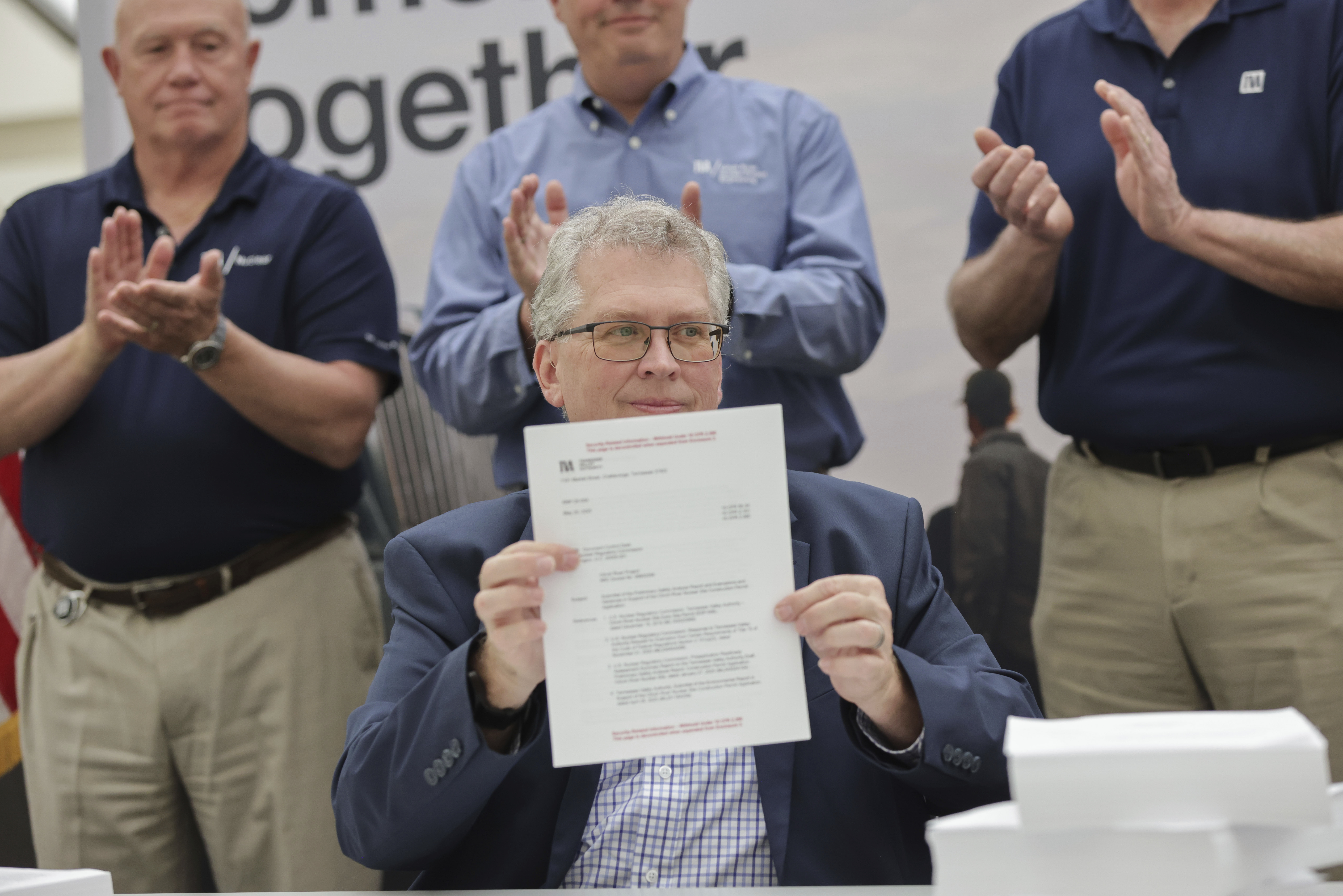 In this photo provided by Tennessee Valley Authority, Scott Hunnewell, vice president of the utility’s New Nuclear Program, signs the construction permit application to build a small modular reactor, Monday, May 19, 2025, in Chattanooga, Tenn. (Tennessee Valley Authority via AP)