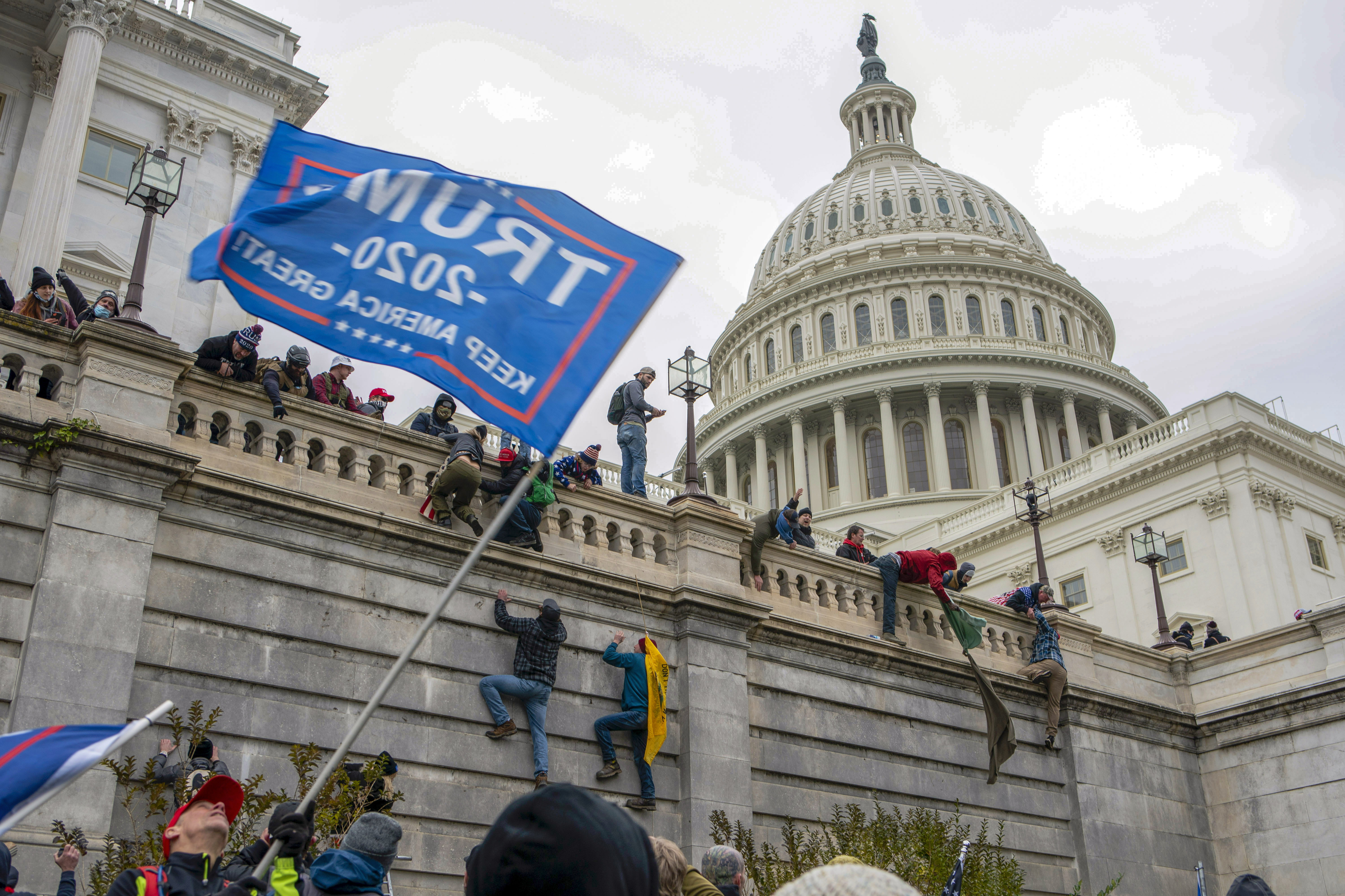 FILE - Support of President Donald Trump climb the West Wall of the the U.S. Capitol on Jan. 6, 2021, in Washington. (AP Photo/Jose Luis Magana, file)