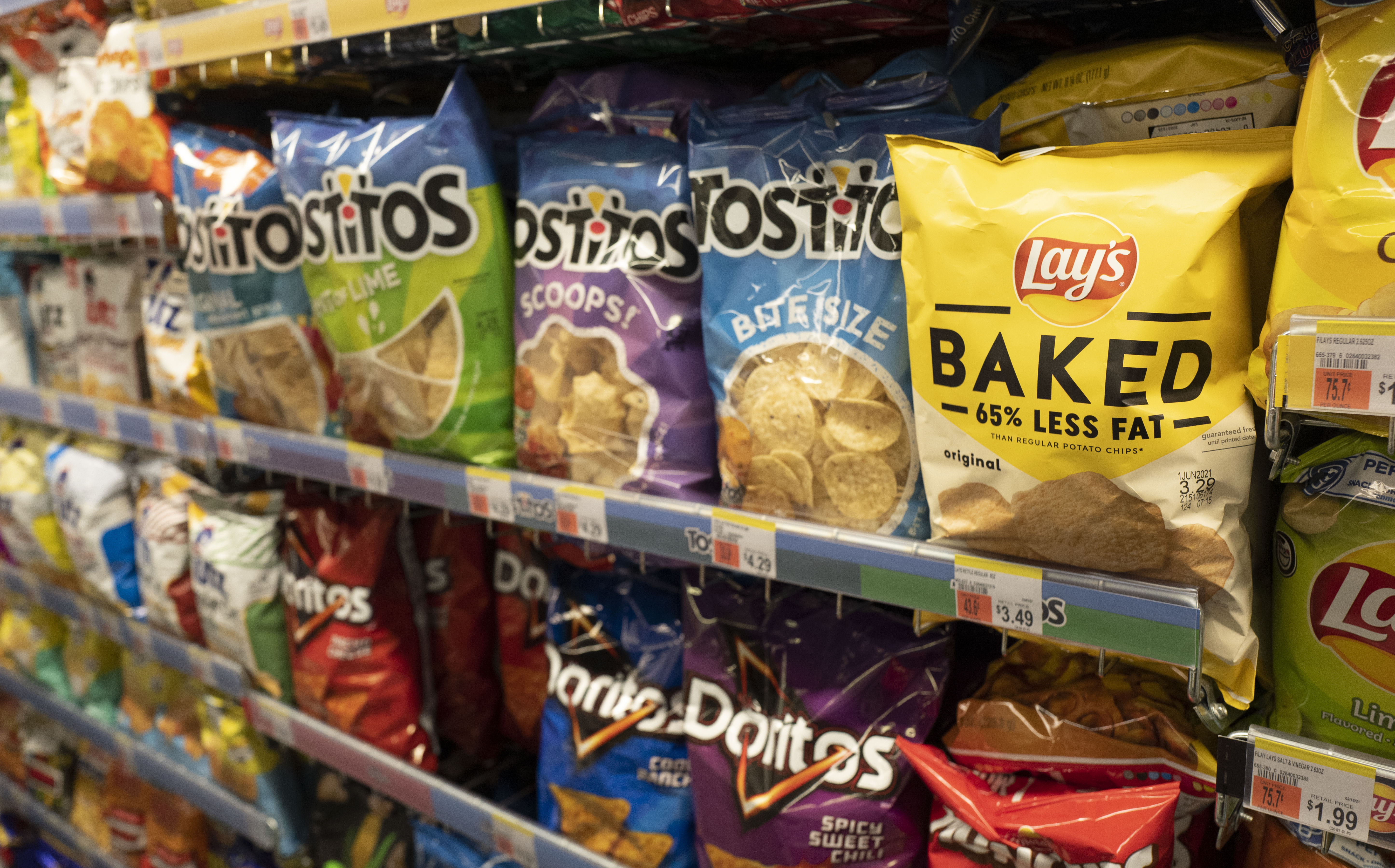 FILE - Potato chips are displayed in pharmacy Duane Reade by Walgreens, Thursday, March 25, 2021, in New York. Walgreens reports earnings March 31, 2021. (AP Photo/Mark Lennihan, file)