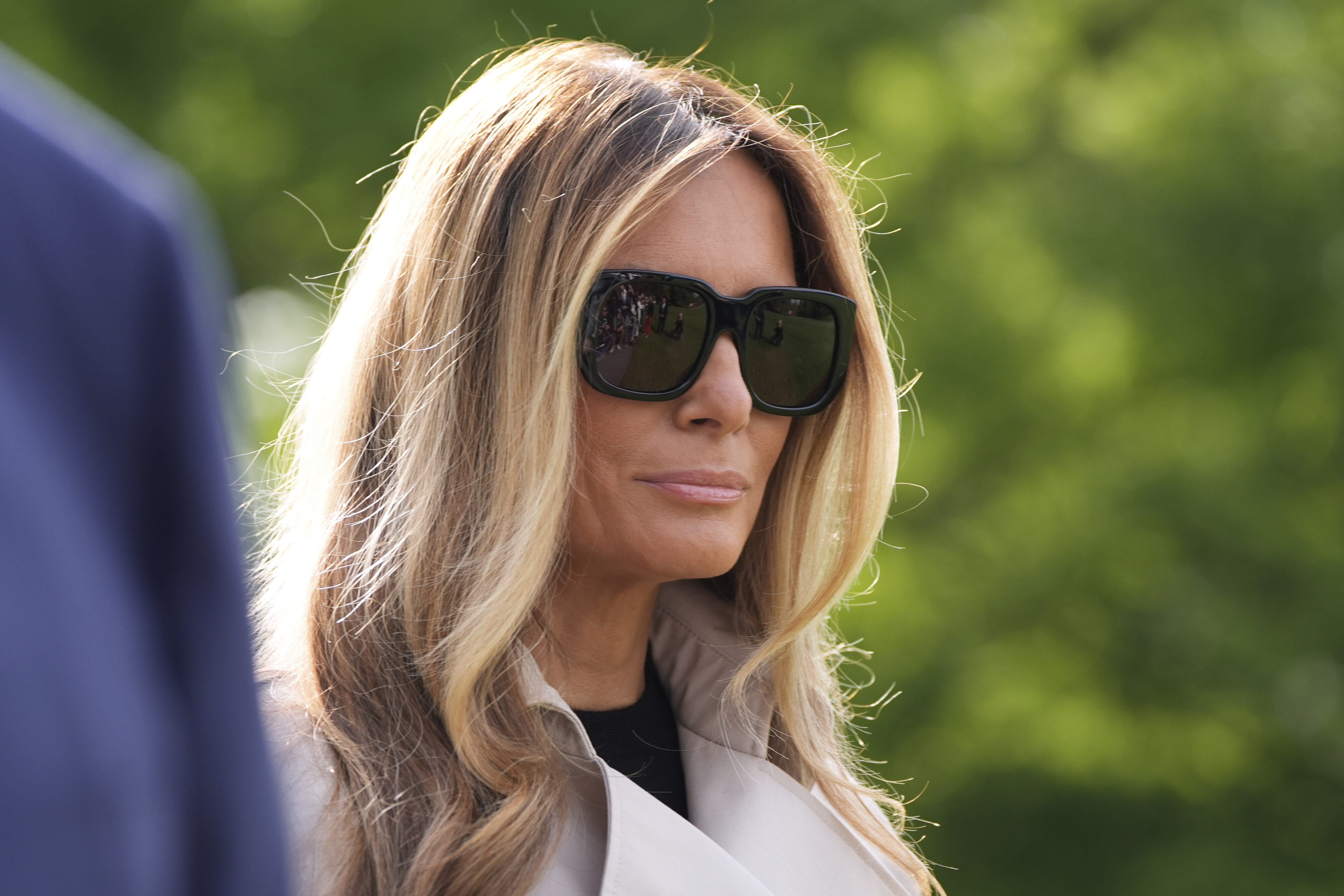 First lady Melania Trump listens as President Donald Trump speaks with reporters as she and the President depart on Marine One from the South Lawn of the White House, Friday, April 25, 2025, in Washington. The President and first lady will be traveling to Rome and the Vatican to attend the funeral for Pope Francis. (AP Photo/Alex Brandon)