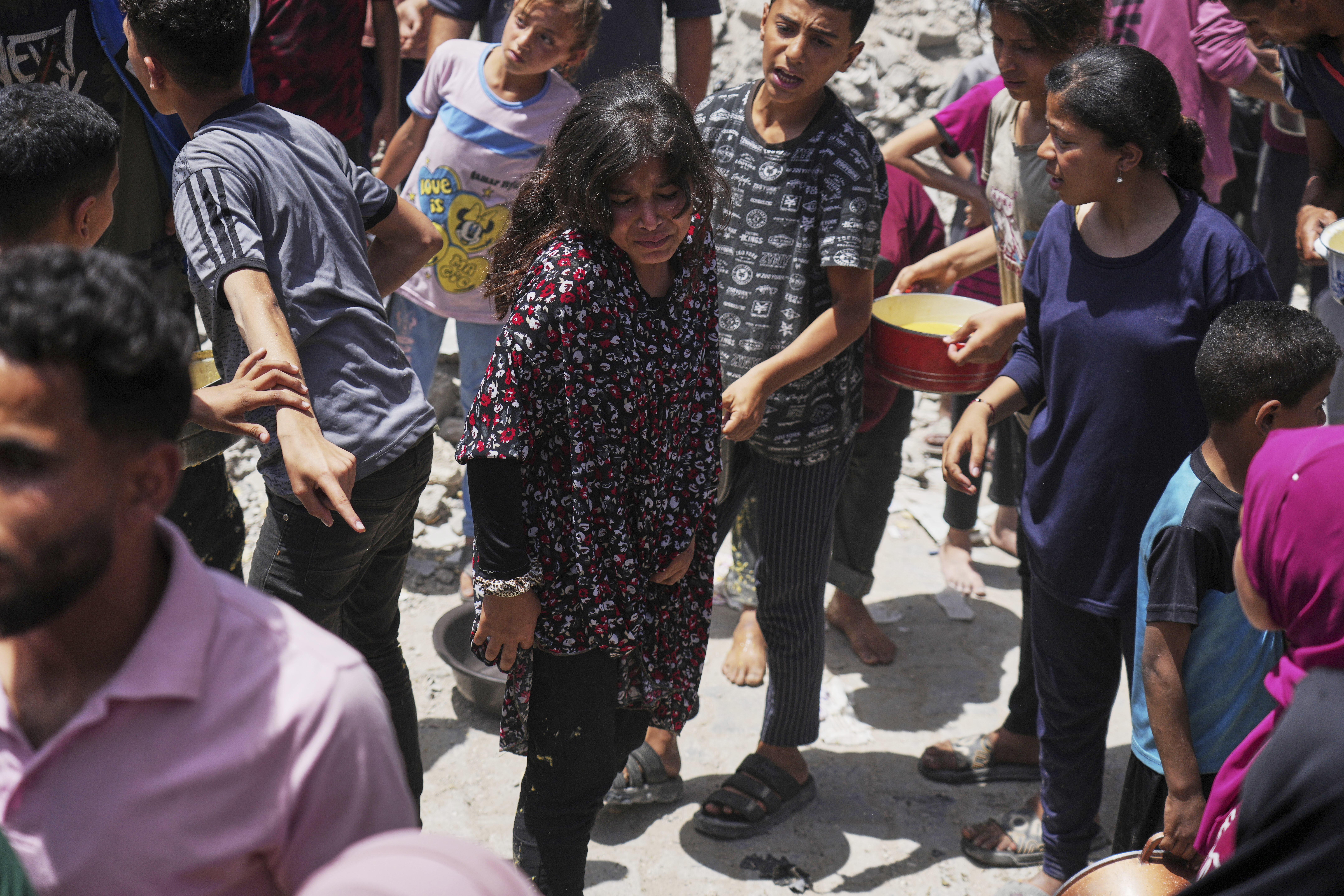 Palestinians line up for donated food at a community kitchen in Jabalia, in the northern Gaza Strip, on Monday, May 19, 2025. (AP Photo/Jehad Alshrafi)