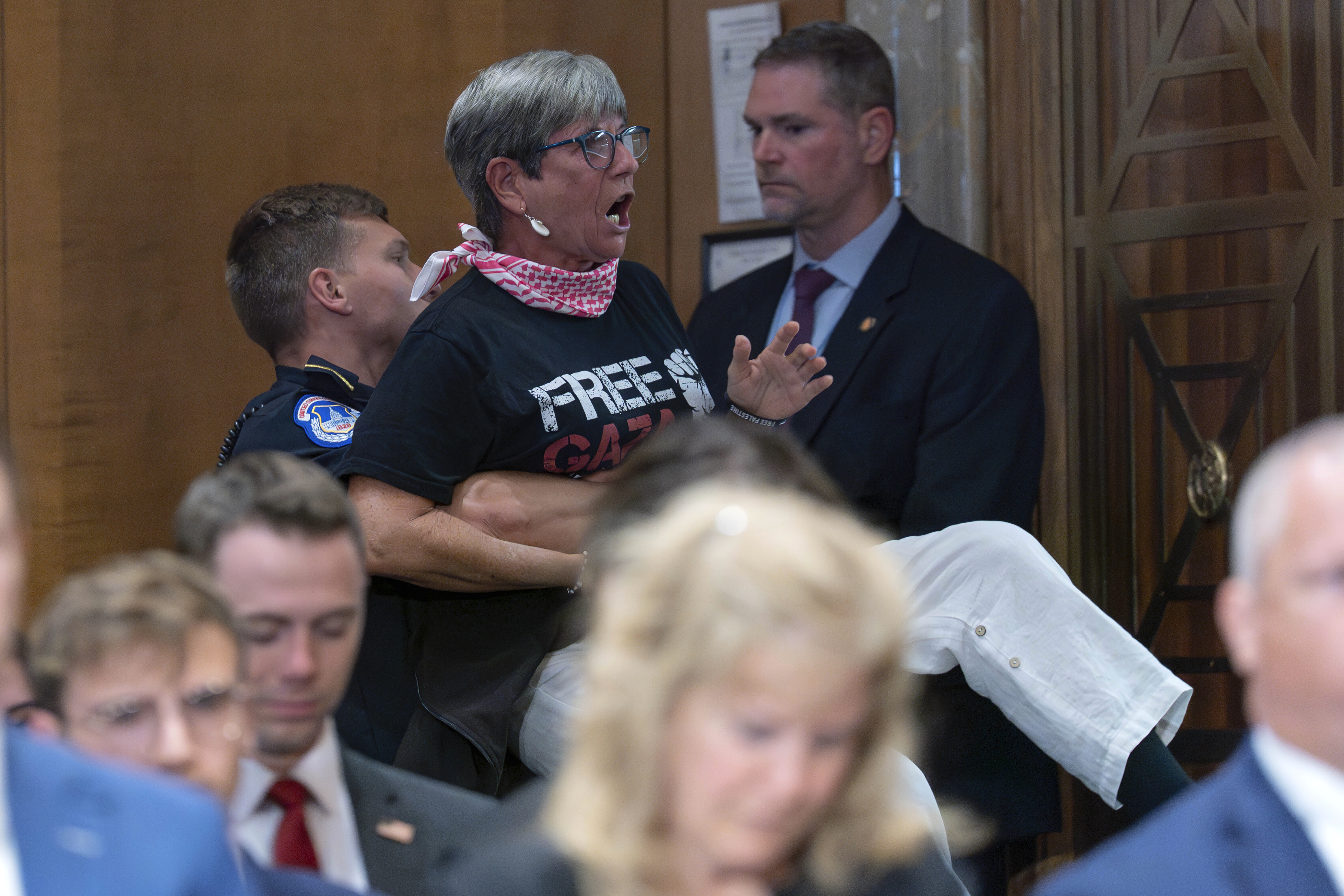 A demonstrator is taken out of the room as Secretary of State Marco Rubio testifies before the Senate Committee on Foreign Relations hearing to examine the President's proposed budget request for fiscal year 2026 for the Department of State on Capitol Hill in Washington, Tuesday, May 20, 2025. (AP Photo/Jose Luis Magana)