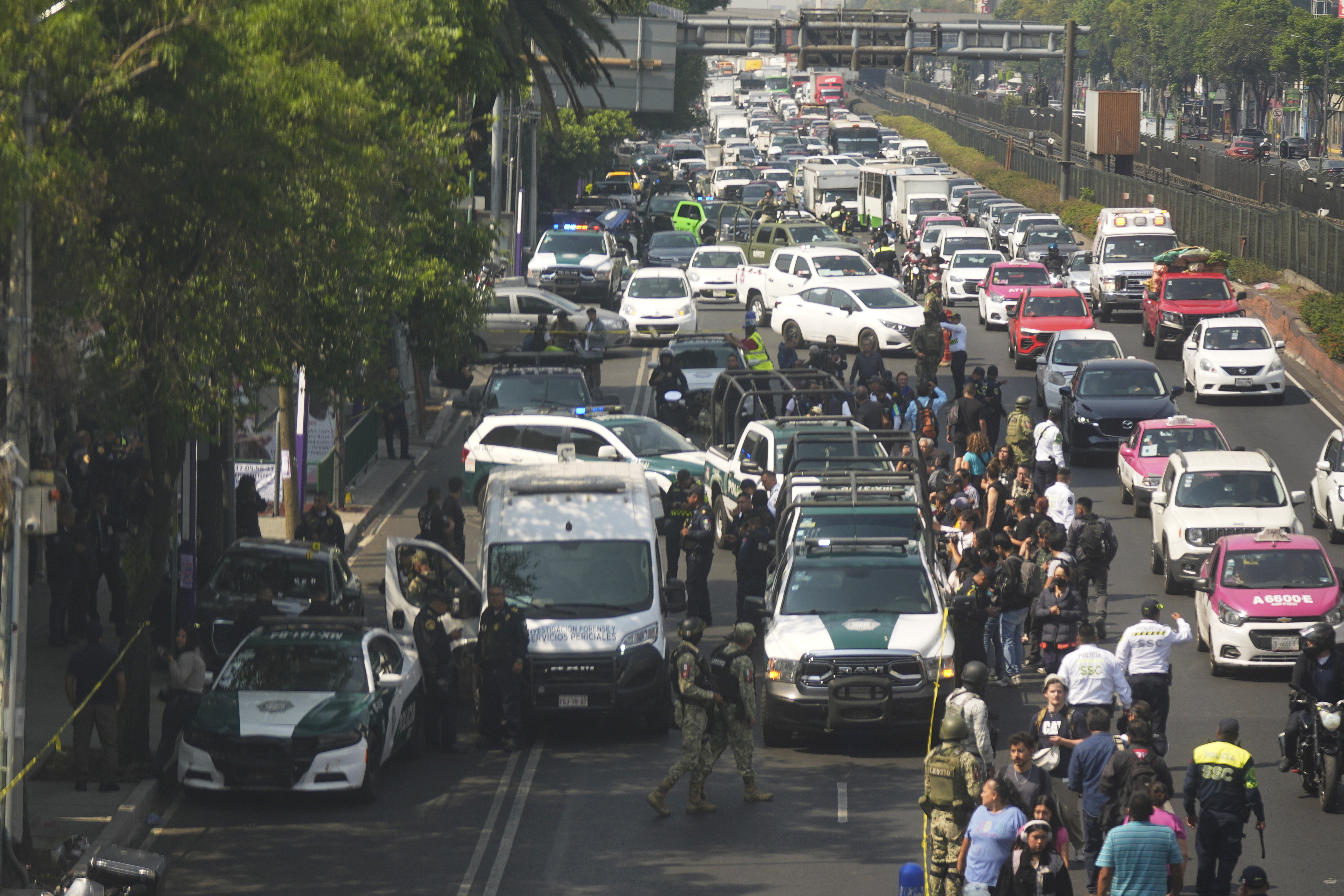Police cordon off the area where Mexico City Mayor Clara Brugada's private secretary, Ximena Guzman, and adviser, Jose Munoz, were killed in Mexico City, Tuesday, May 20, 2025. (AP Photo/Fernando Llano)