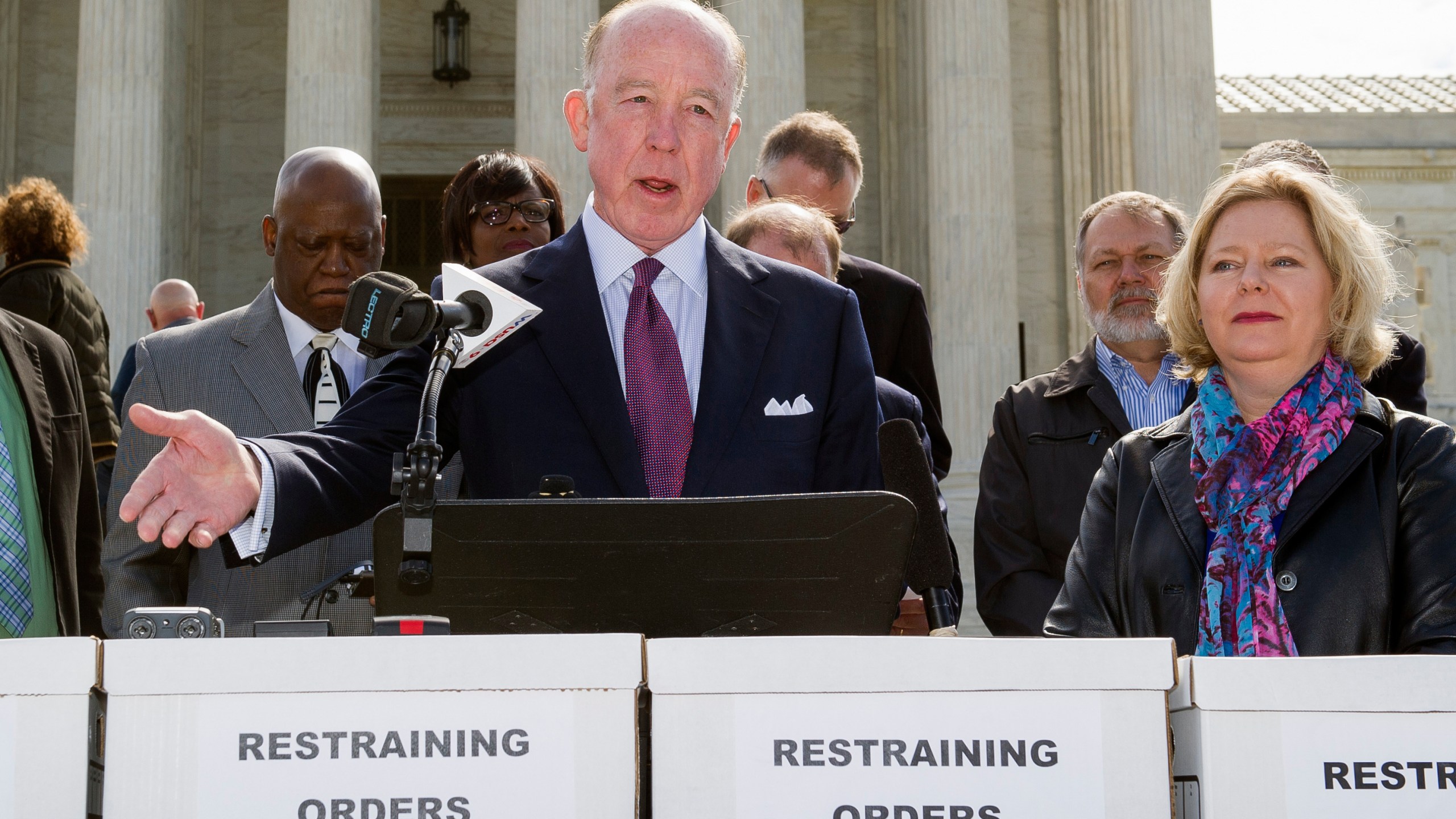 FILE - Dr. Steven Hotze, president of Conservative Republicans of Texas, speaks at a Restrain the Judges news conference, while Janet Porter of Faith2Action listens at right, in front of the Supreme Court in Washington, April 27, 2015. (AP Photo/Cliff Owen, File)