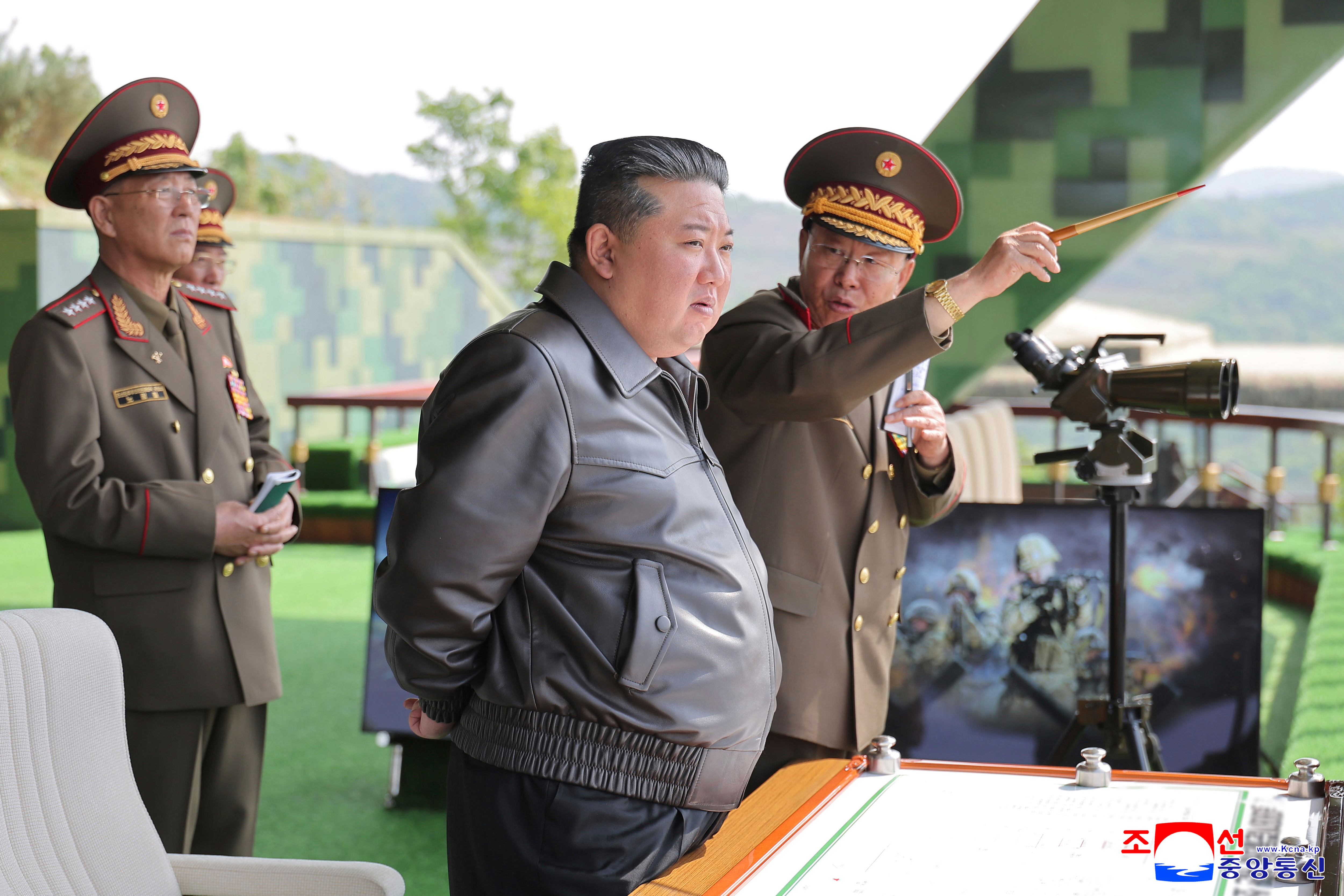 In this photo provided by the North Korean government, North Korean leader Kim Jong Un, center, inspects the military exercises at an undisclosed place in North Korea, Tuesday, May 13, 2025. Independent journalists were not given access to cover the event depicted in this image distributed by the North Korean government. The content of this image is as provided and cannot be independently verified. Korean language watermark on image as provided by source reads: "KCNA" which is the abbreviation for Korean Central News Agency. (Korean Central News Agency/Korea News Service via AP)