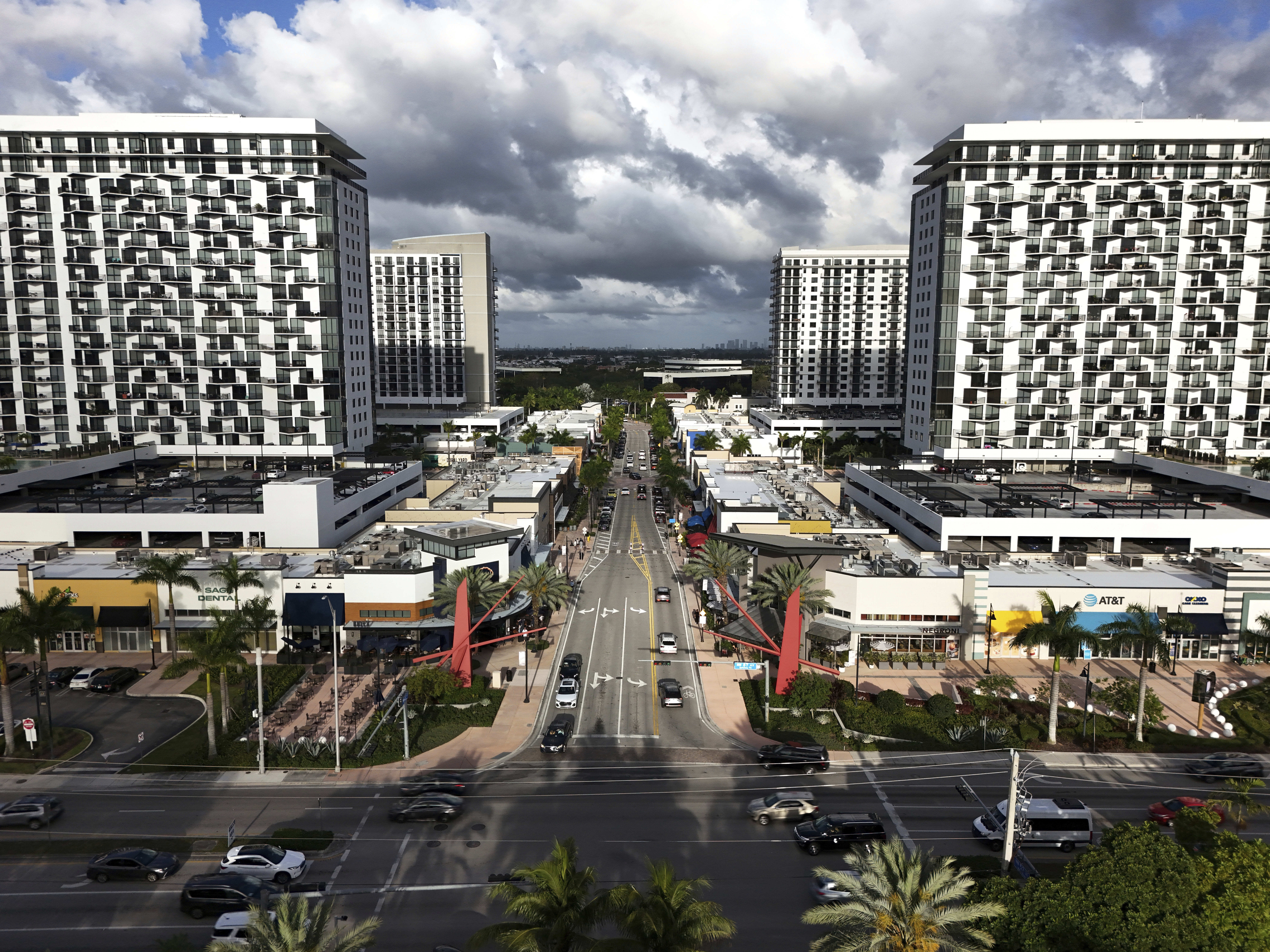 FILE - Cars pass through the area known as Downtown Doral, April 5, 2025, in Doral, Fla. (AP Photo/Rebecca Blackwell, File)