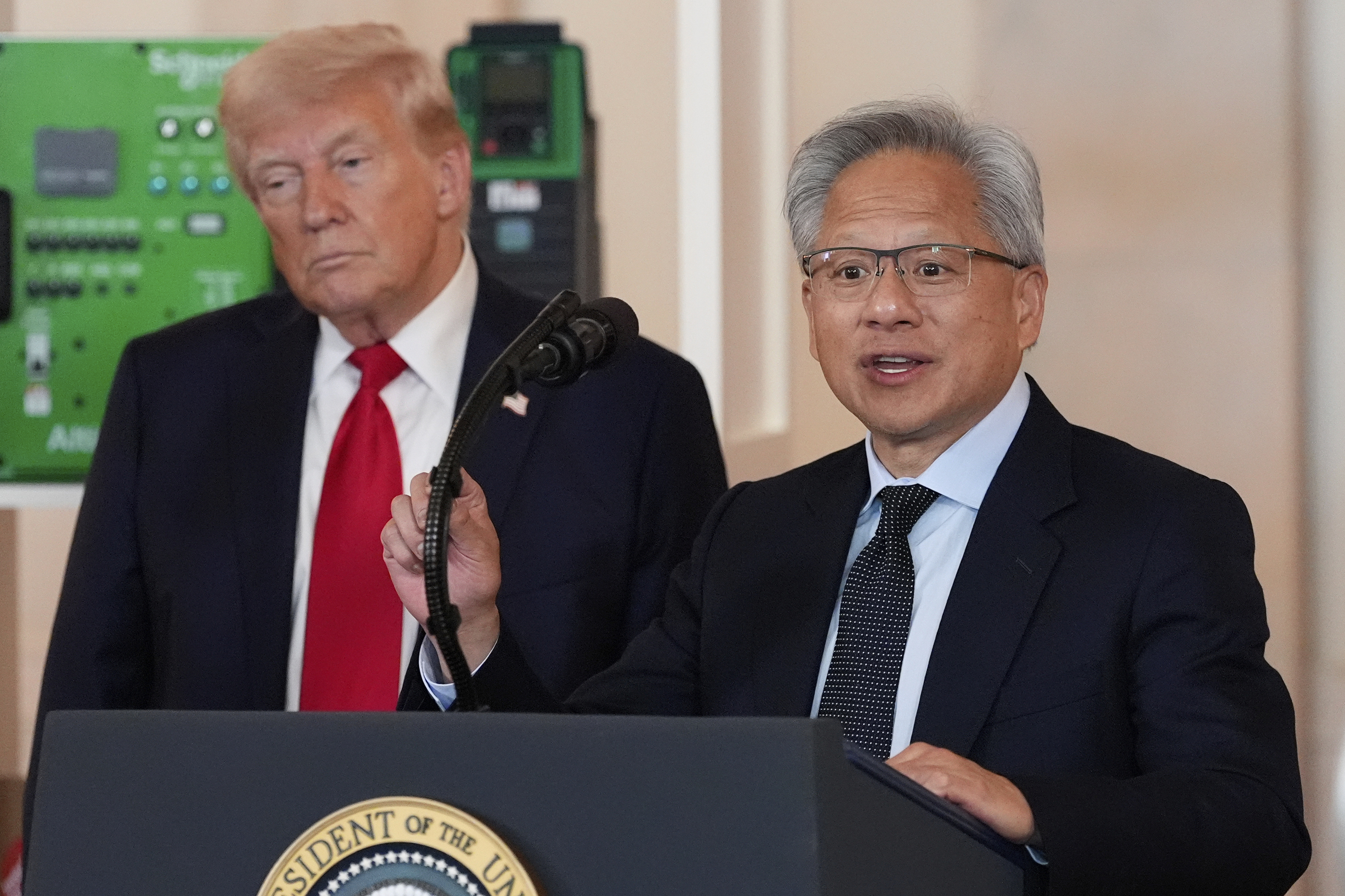 President Donald Trump listens as Nvidia CEO Jensen Huang speaks during an event about investing in America in the Cross Hall of the White House, Wednesday, April 30, 2025, in Washington. (AP Photo/Alex Brandon)