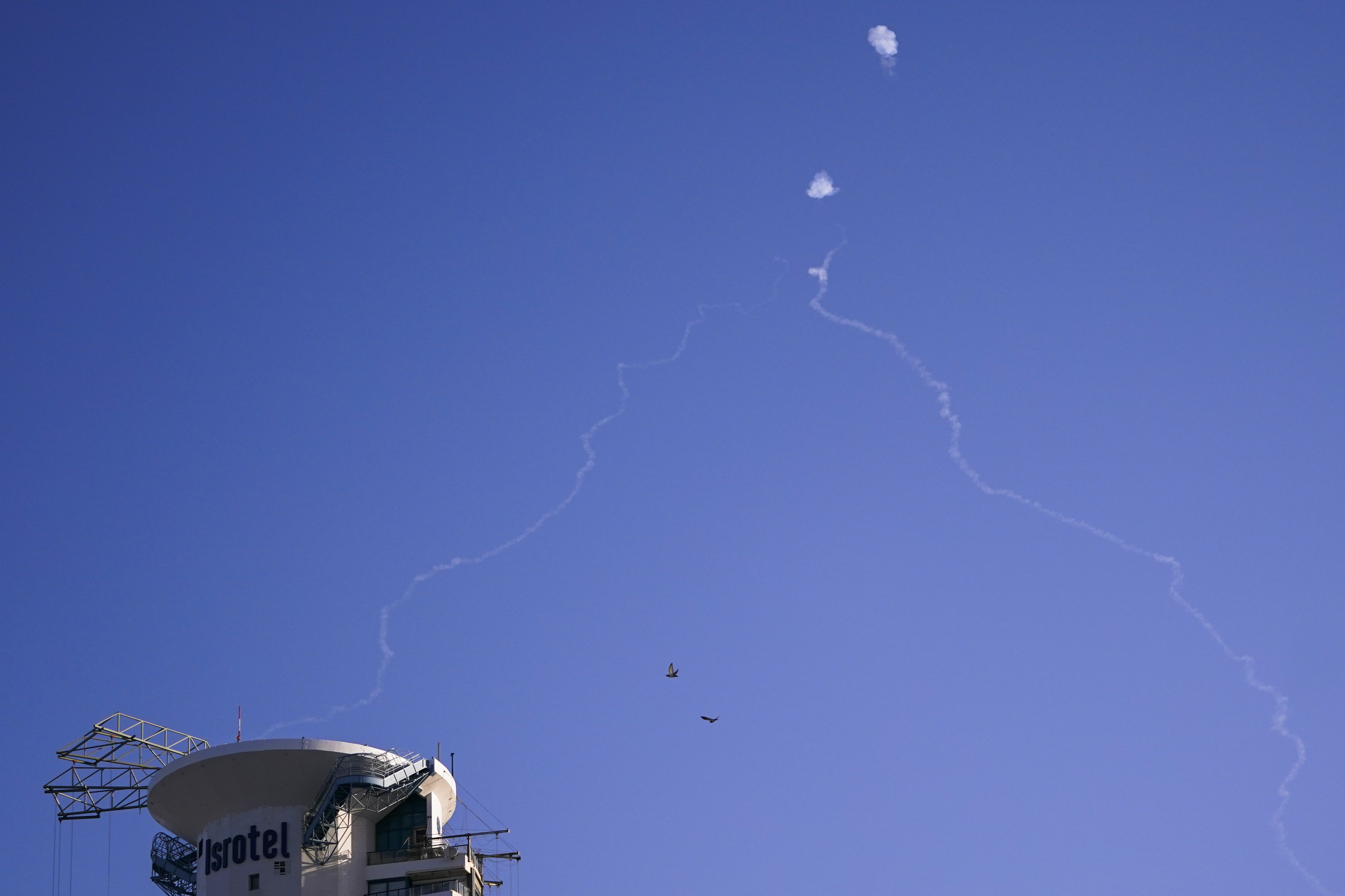 FILE - Israel's Iron Dome anti-missile system fires to intercept as air raid sirens sound in Tel Aviv, on Oct. 23, 2024. (Nathan Howard/Pool Photo via AP, File)